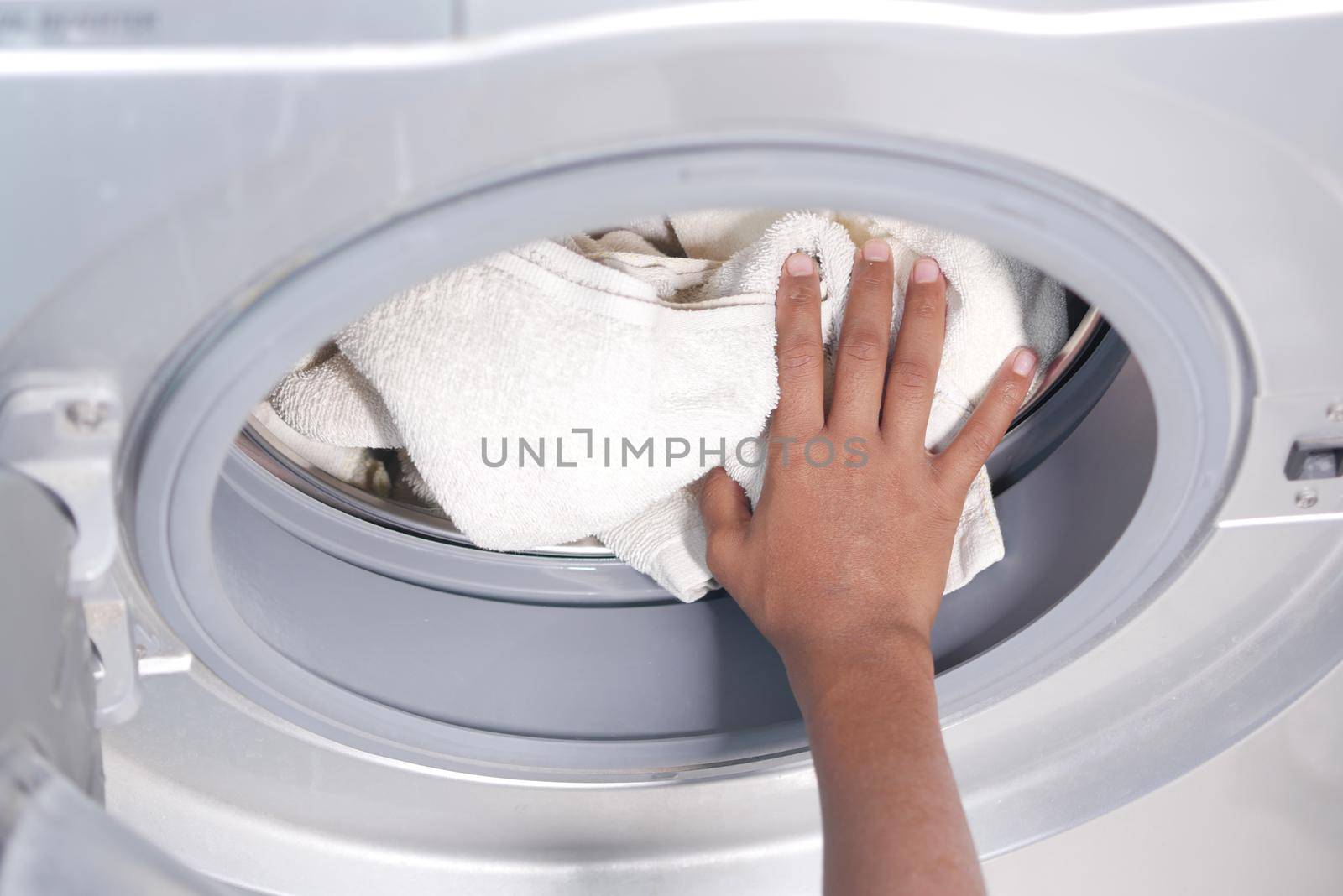 putting towel and cloths in a washing machine