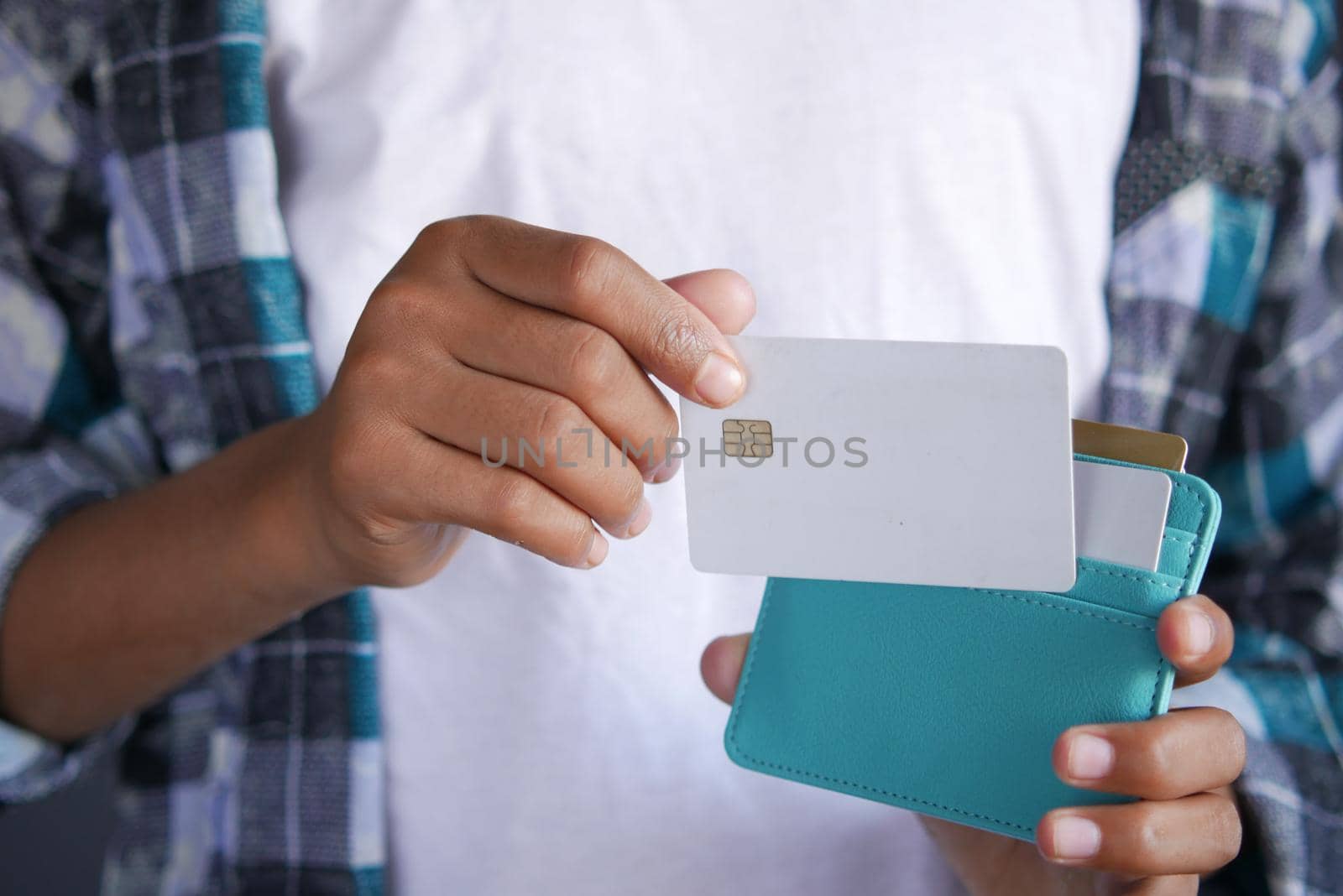 man hand taking credit card out from a wallet .