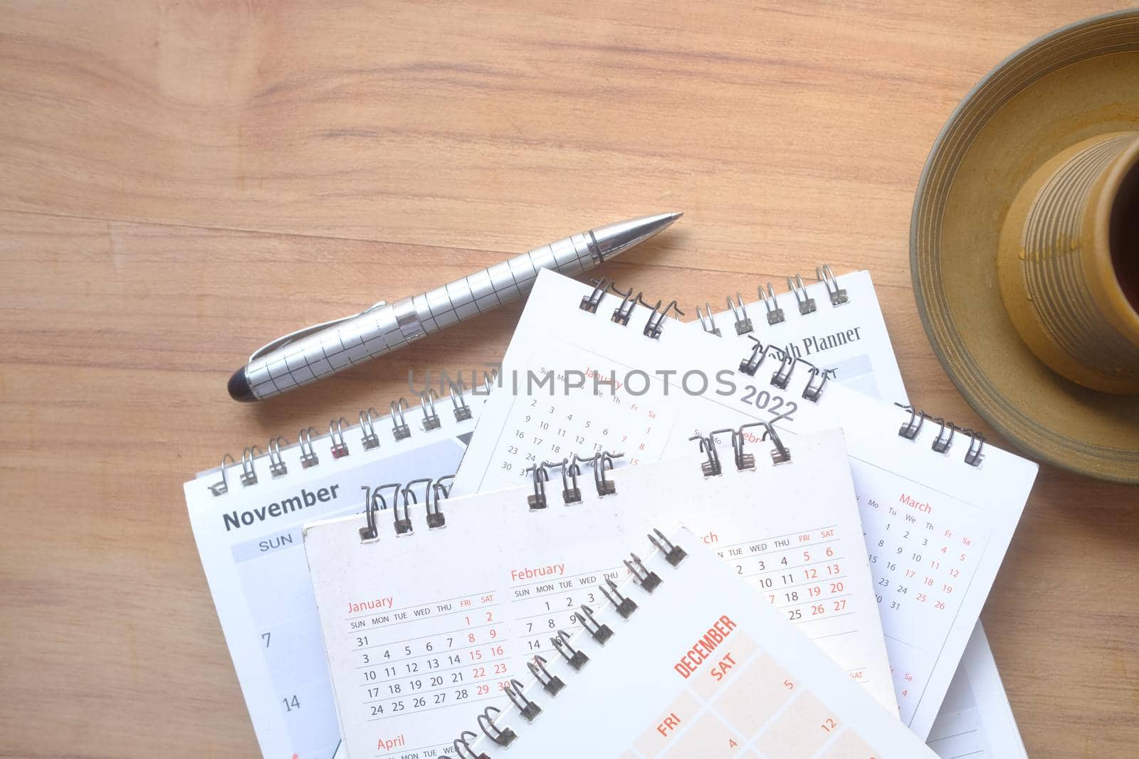 deadline concept with stack of calendar and pencil on color background .
