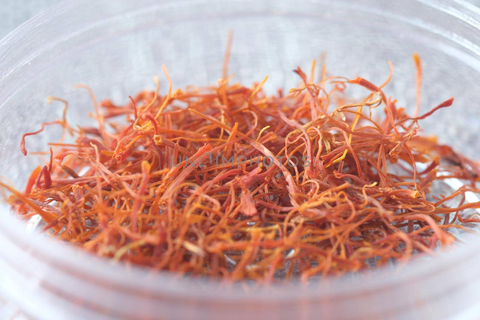Saffron Spice in a container on table close up .