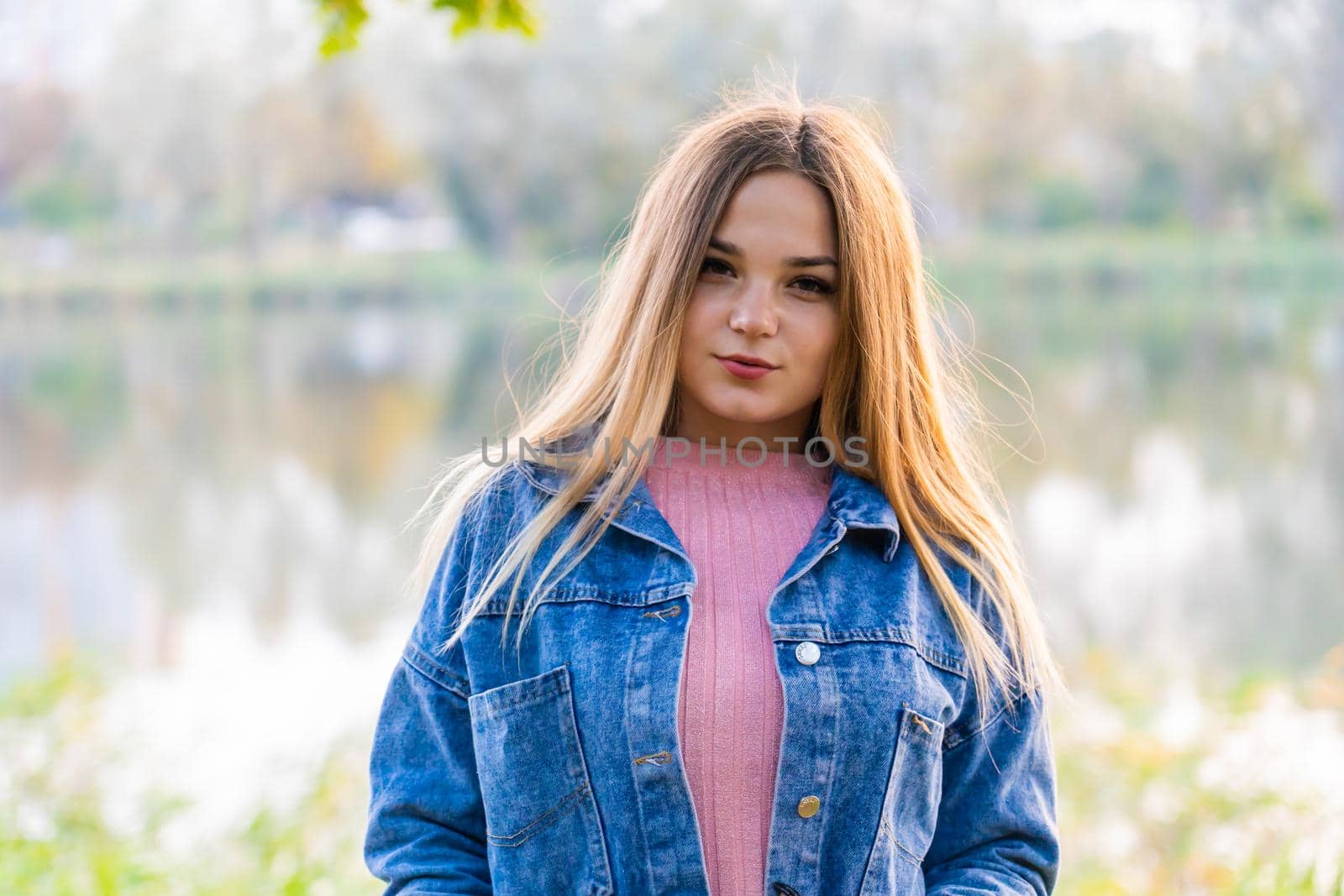 A young girl poses posing in a warm autumn evening