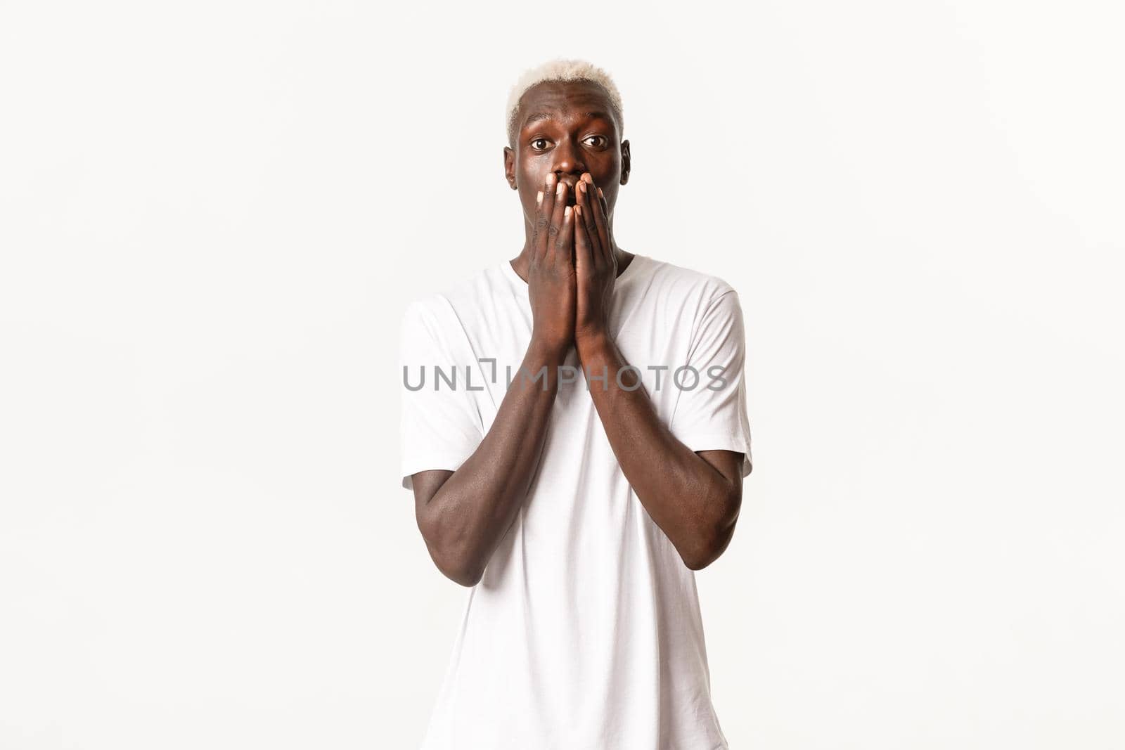 Portrait of impressed and surprised african-american guy, gasping wondered and looking at camera thrilled, standing white background by Benzoix