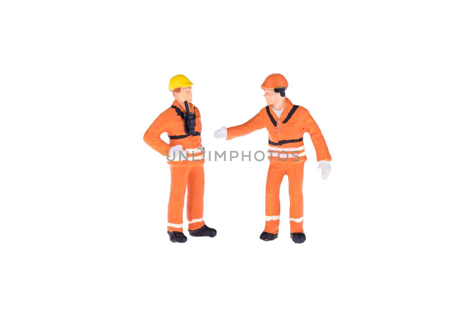 Close up of Miniature people in engineer and worker occupation isolate on white background. by Nuamfolio