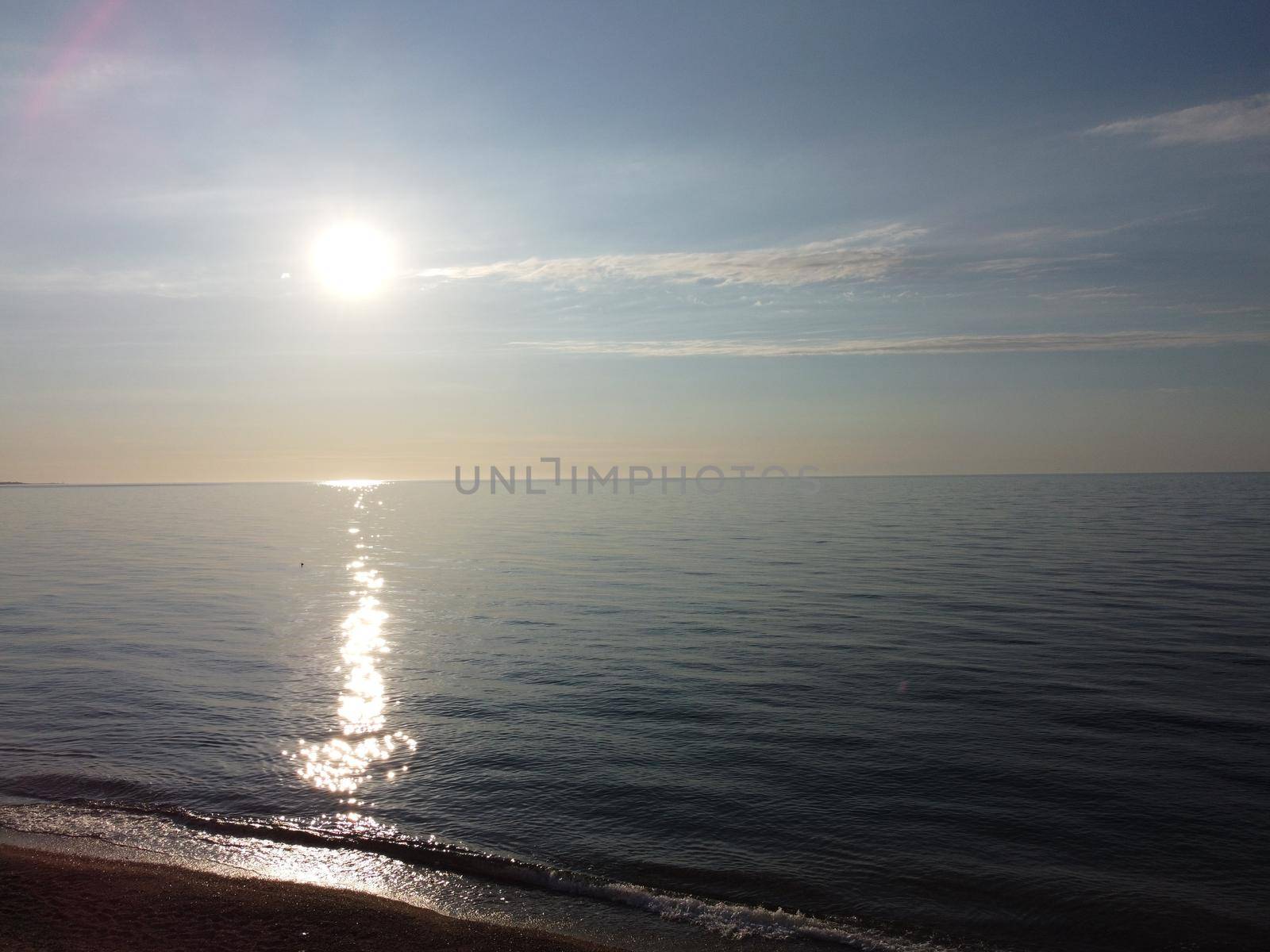 Beautiful remote beach with crystal clear azure water, aerial view. Untouched nature and hidden sandy beach with seagulls. Motion blur on small waves. Holiday, vacation and travel concept. Nobody by panophotograph