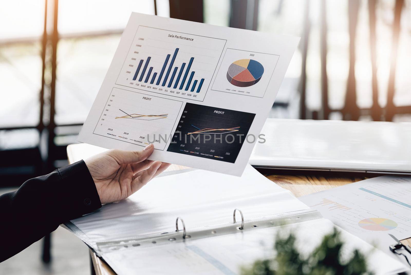 Businesswoman holding a sale performance paper to analyze sales profits