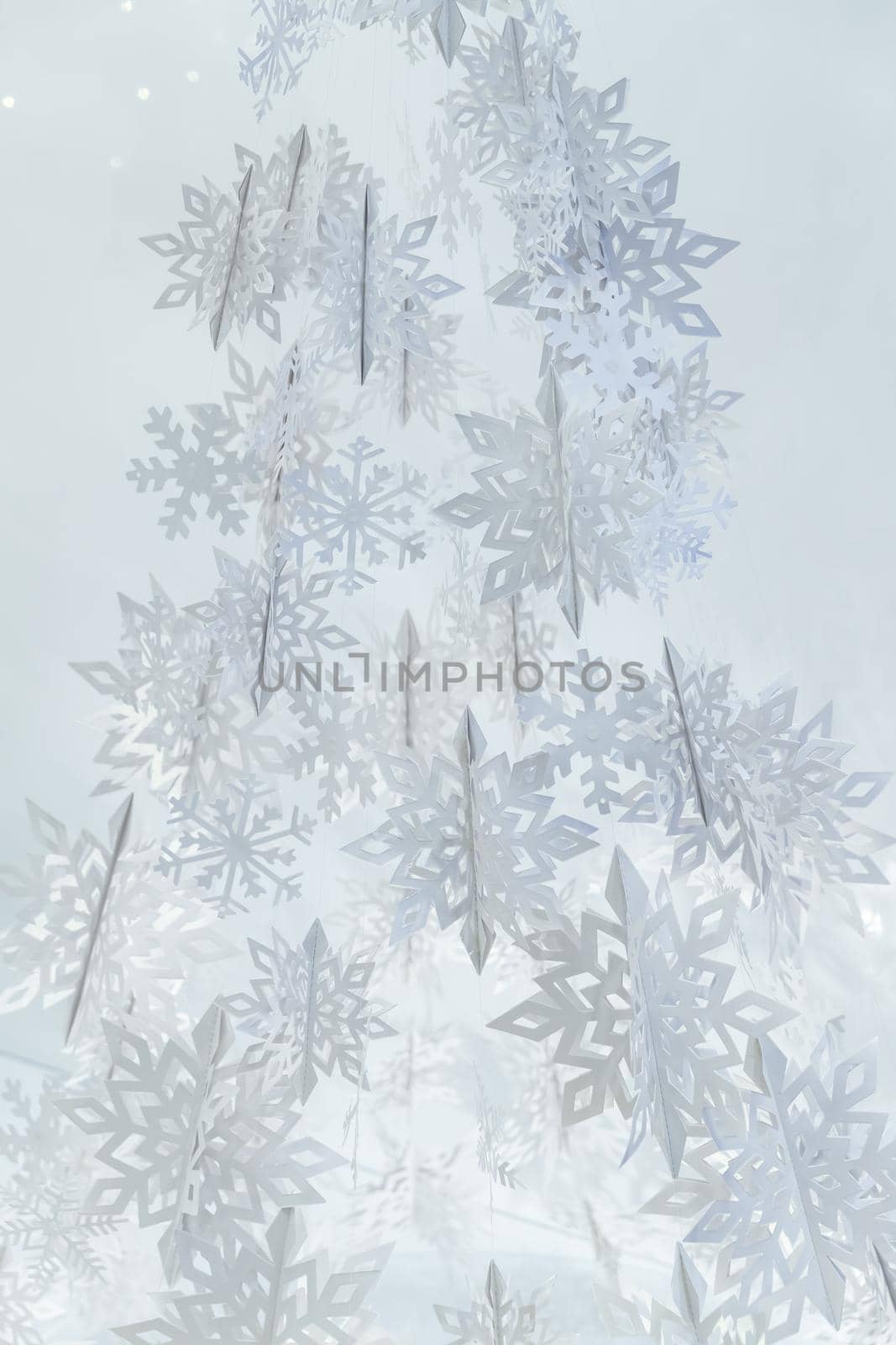 Decoration of paper white snowflakes in the form of a Christmas tree. High quality photo
