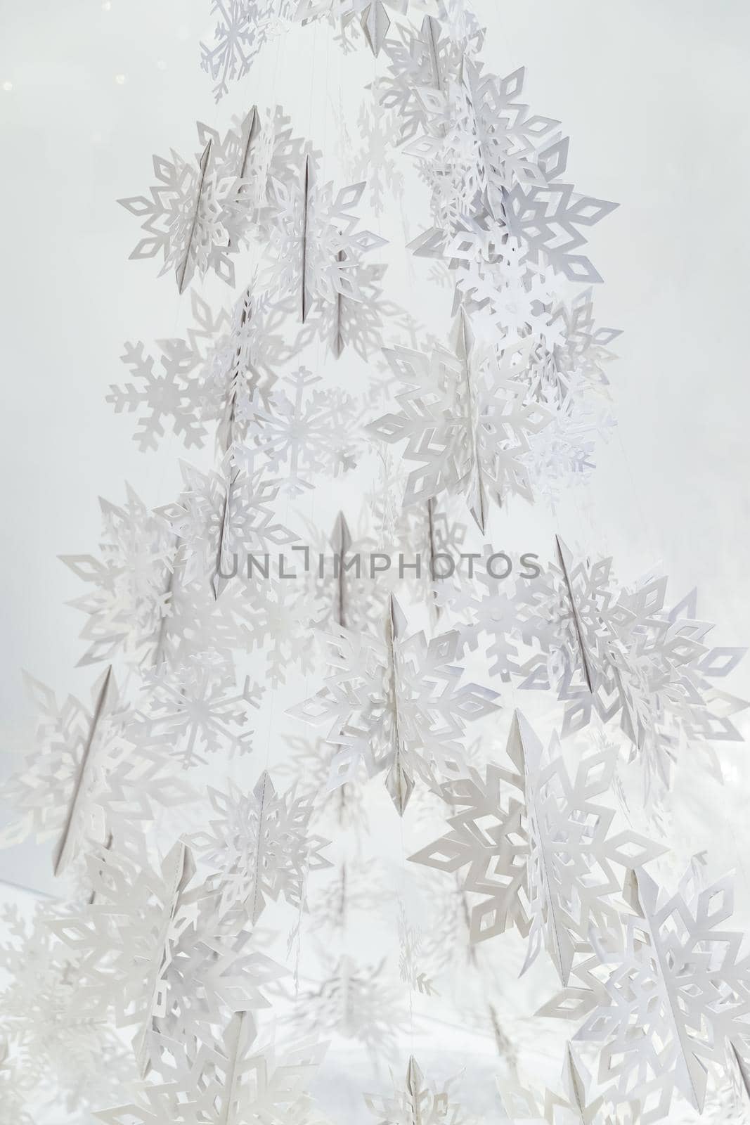 Decoration of paper white snowflakes in the form of a Christmas tree. High quality photo