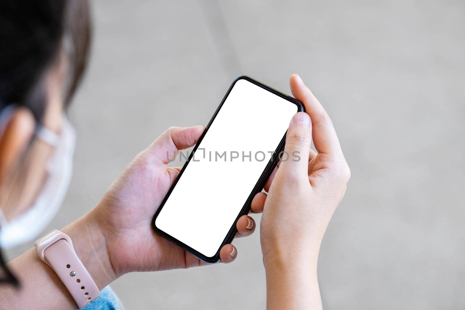 A woman holding a cell phone with a blank white screen. The blank space on the white screen can be used to write a message or place an image. by Manastrong