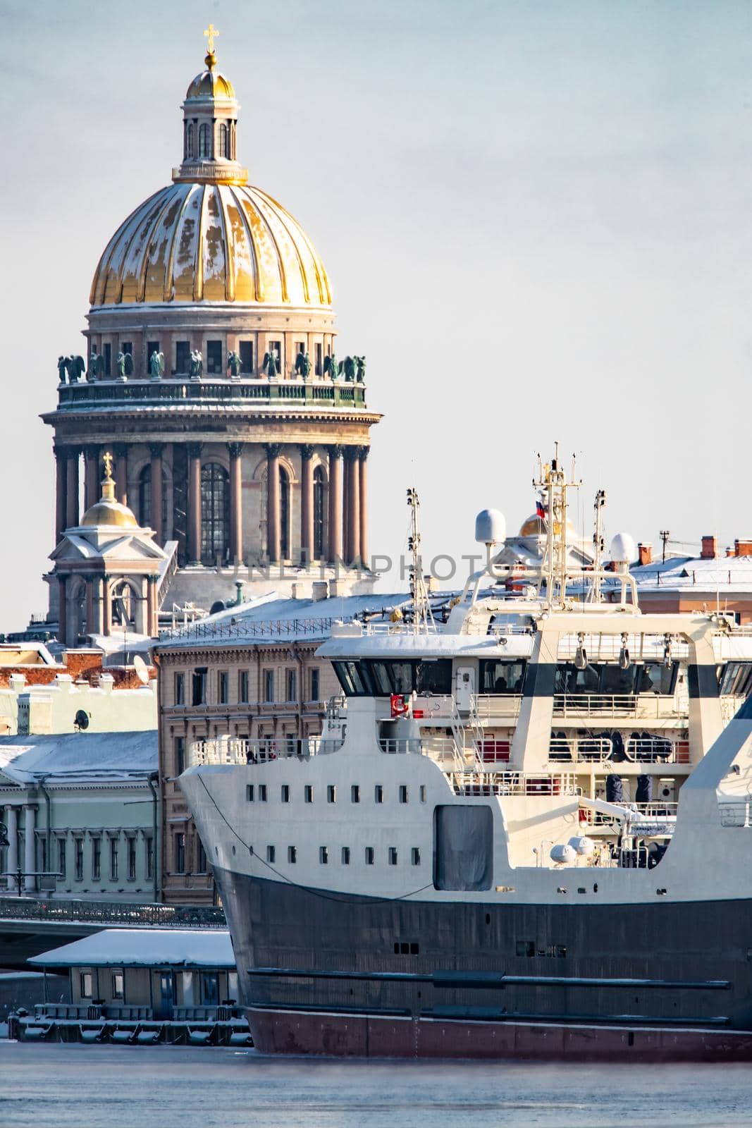 The panoramic view of the winter city Saint-Petersburg, big ship moored near Blagoveshchensky bridge, Isaac cathedral on background. High quality photo