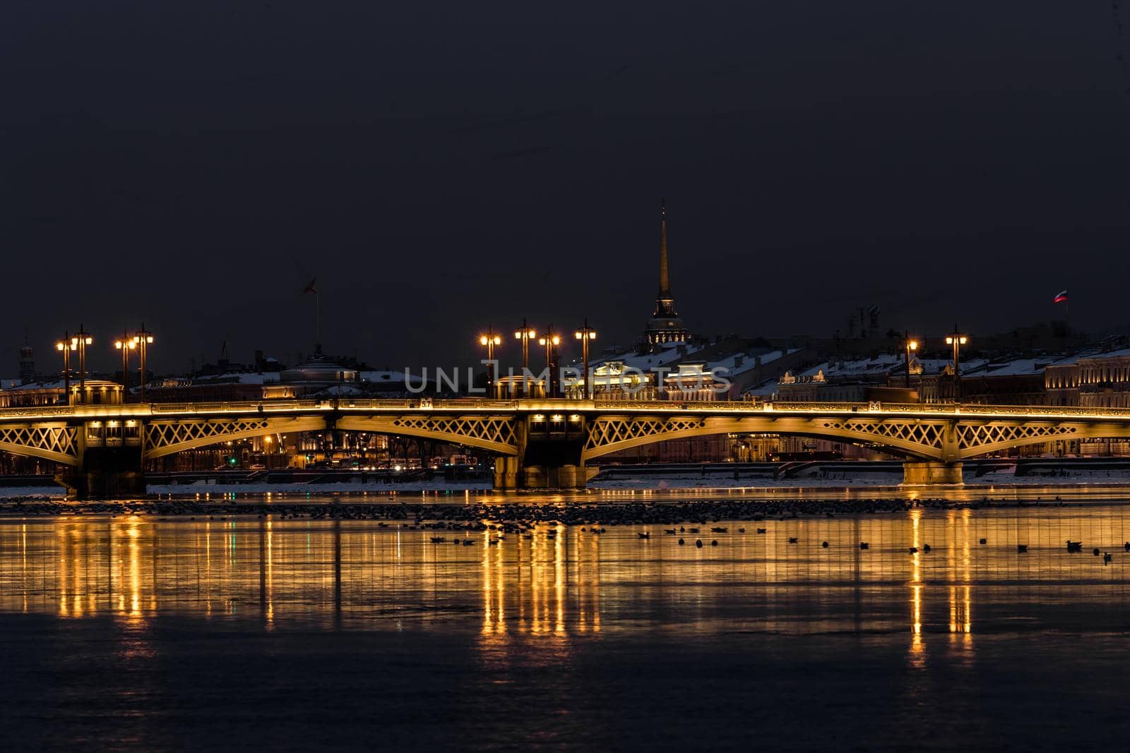 The panoramic footage of the winter night city Saint-Petersburg with picturesque reflection n water, Isaac cathedral on background, Blagoveshchensky bridge, old name is the lieutenant Schmidt. High quality photo