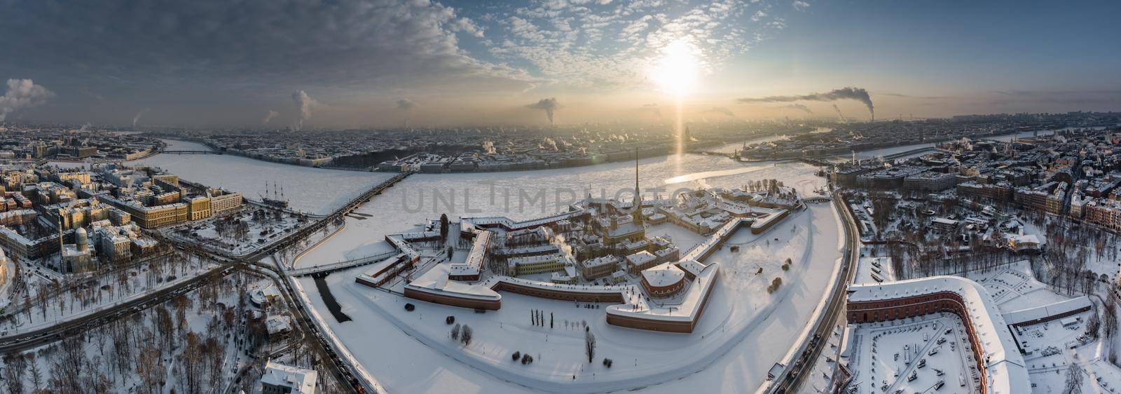 Drone point of view of winter St. Petersburg at sunset, frozen Neva river, steam over city, Peter and Paul fortress, car traffic on Trinity bridge, rostral columns, Palace drawbridge, panoramic view by vladimirdrozdin