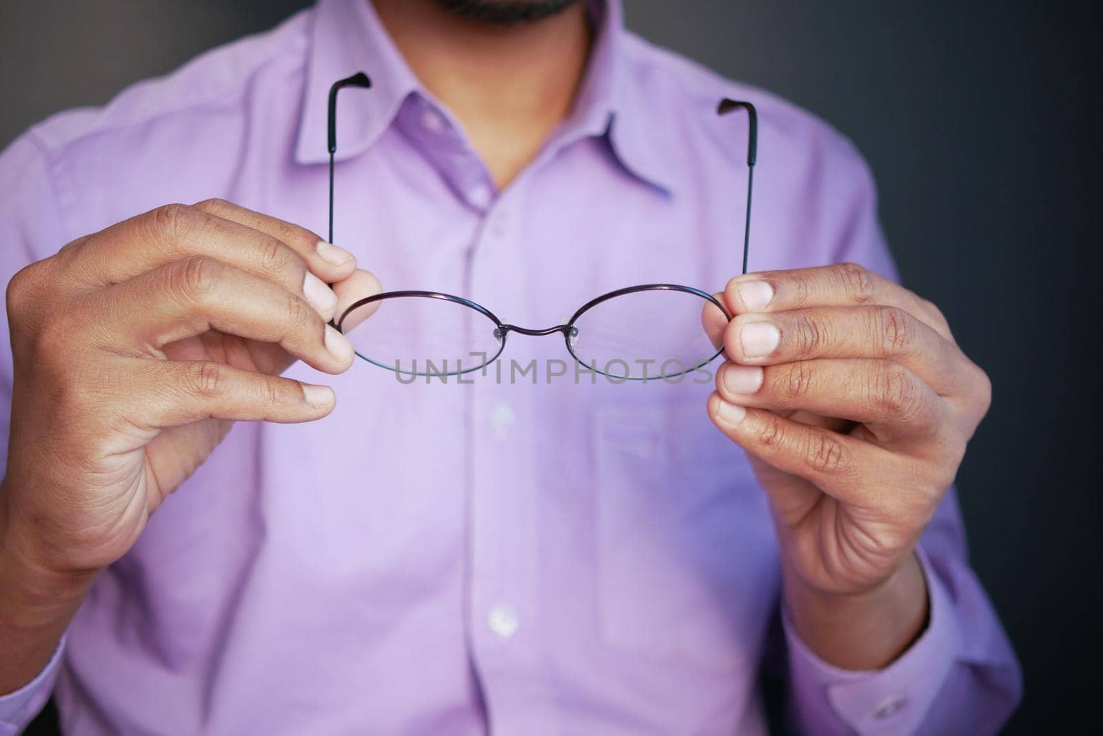 Close up of man hand holding eyeglass,