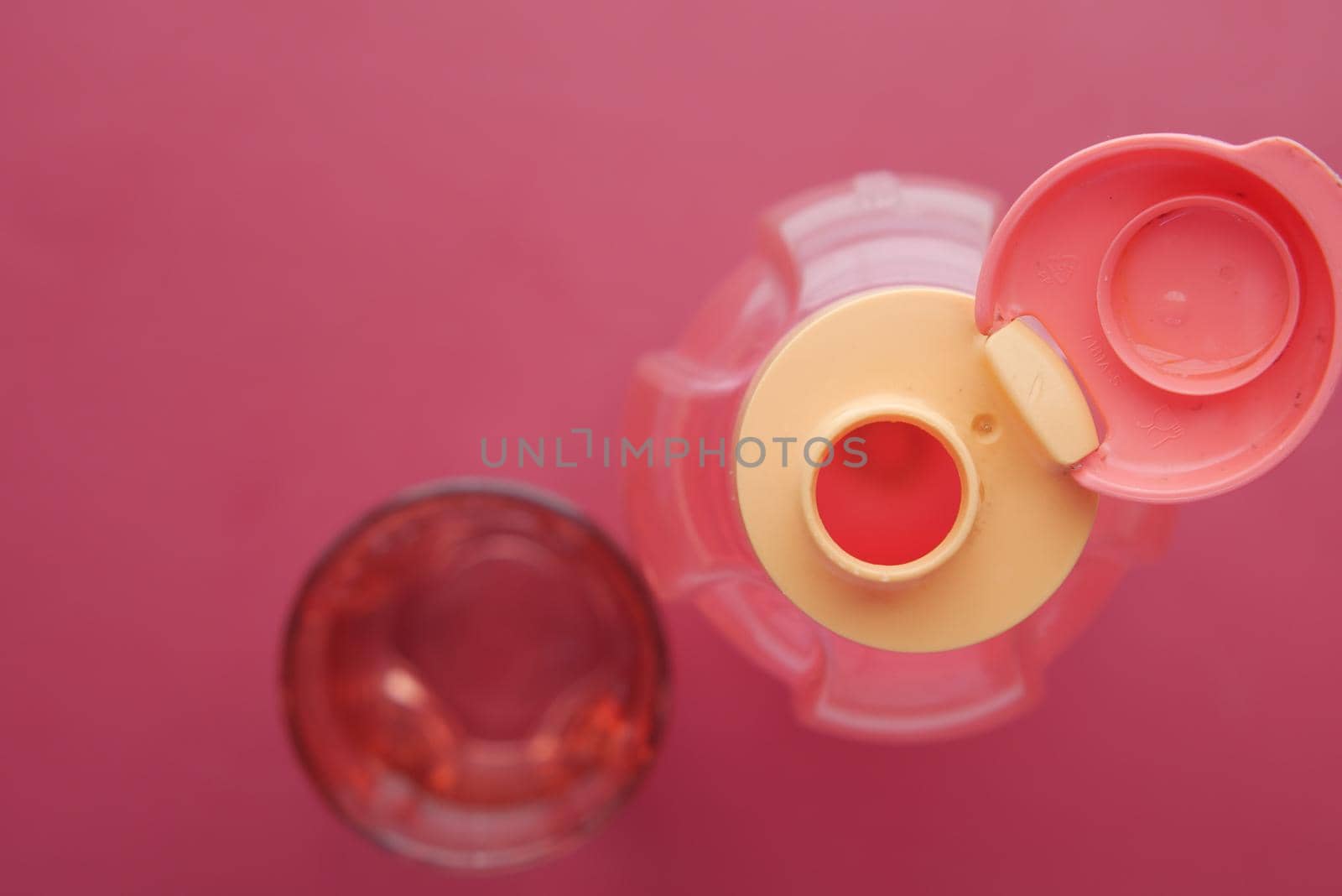 fresh eater in a plastic container on red background .