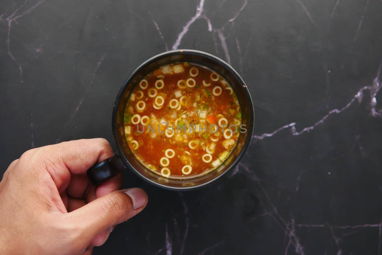 instant cup soup in a mug on table .