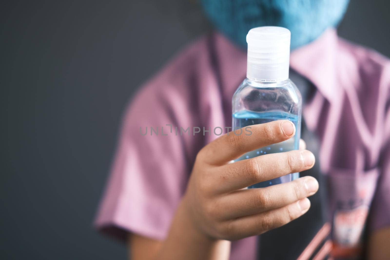 child hand using sanitizer gel for preventing virus with copy space ,