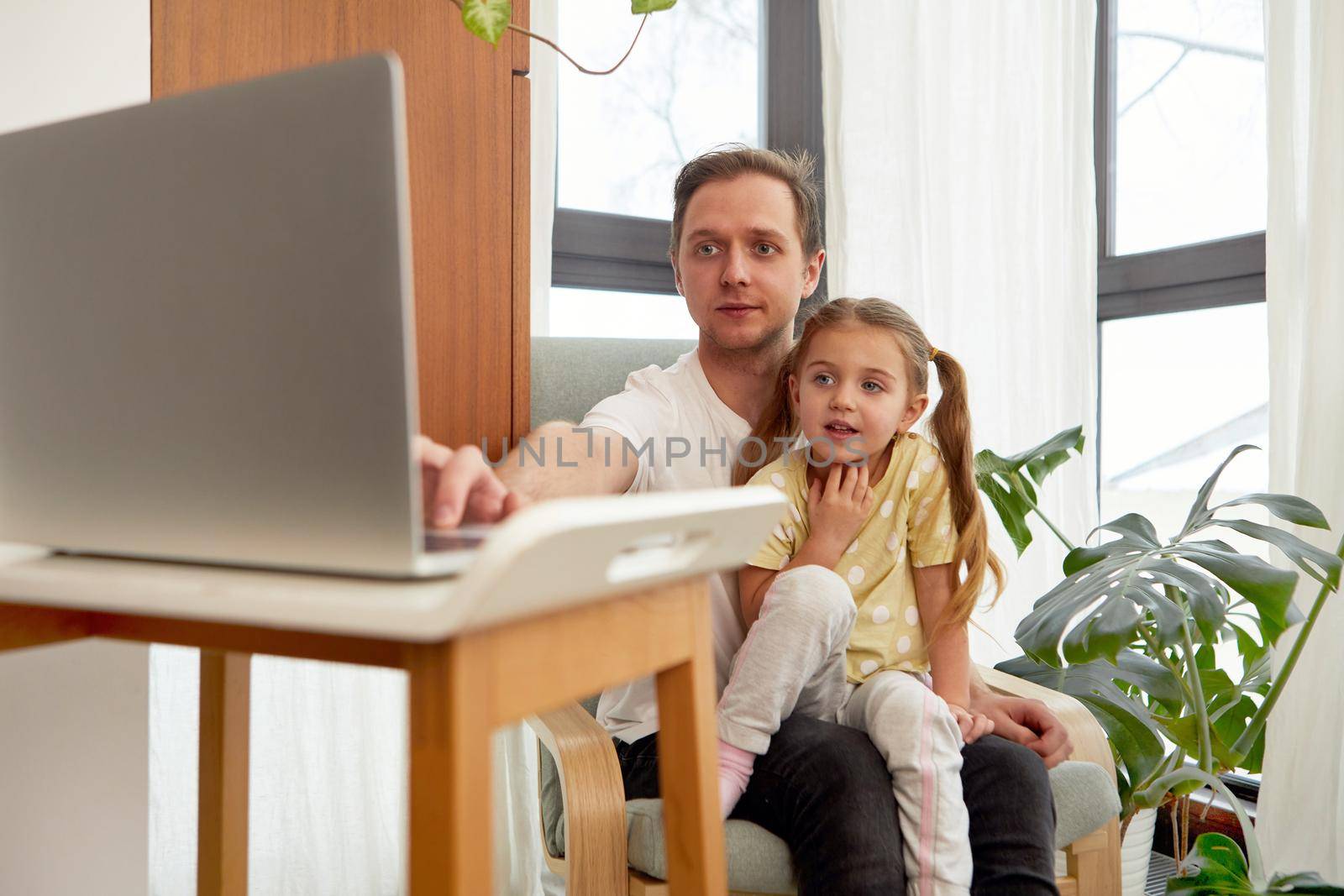 Education Concept. Happy father teaching his little toddler girl how to use personal computer, copy space