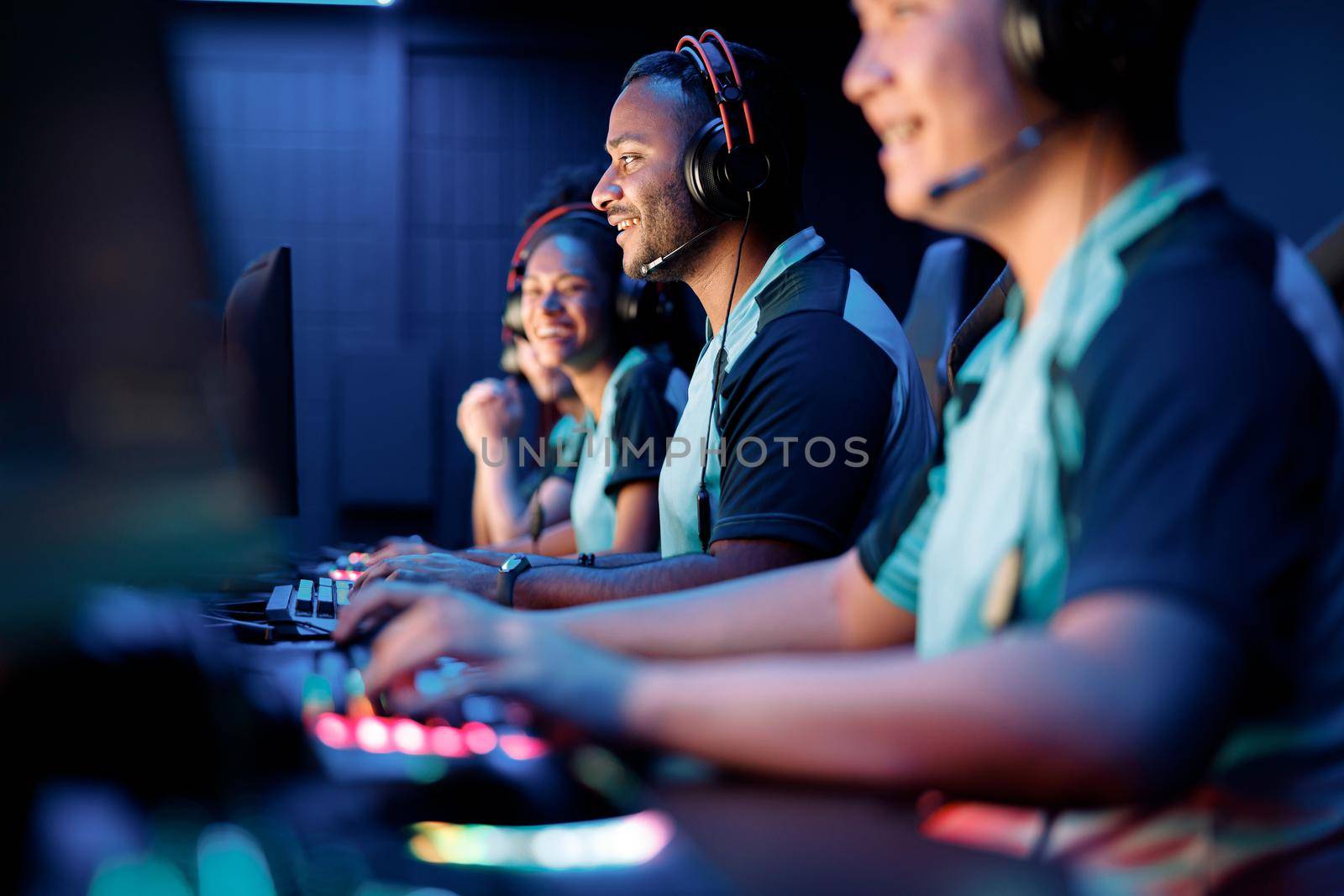 Selective focus on African esports player participating in online video games competition with blurred team members on background