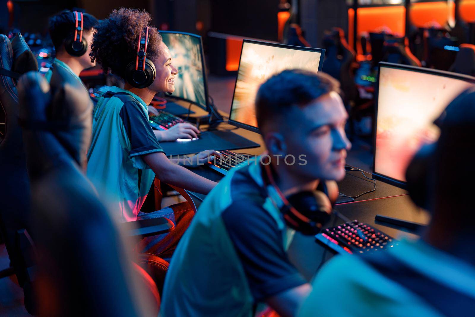 Skillful gamers practicing in gaming arena in internet club by Yaroslav_astakhov