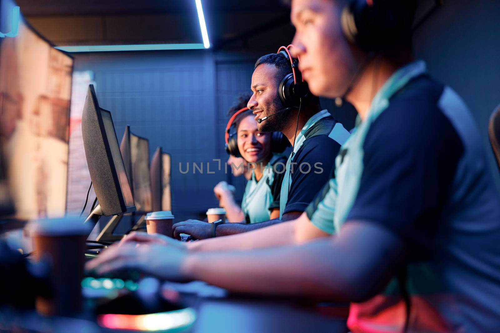 Selective focus on competitive male esports gamer challenging difficult video game competition event in gaming club