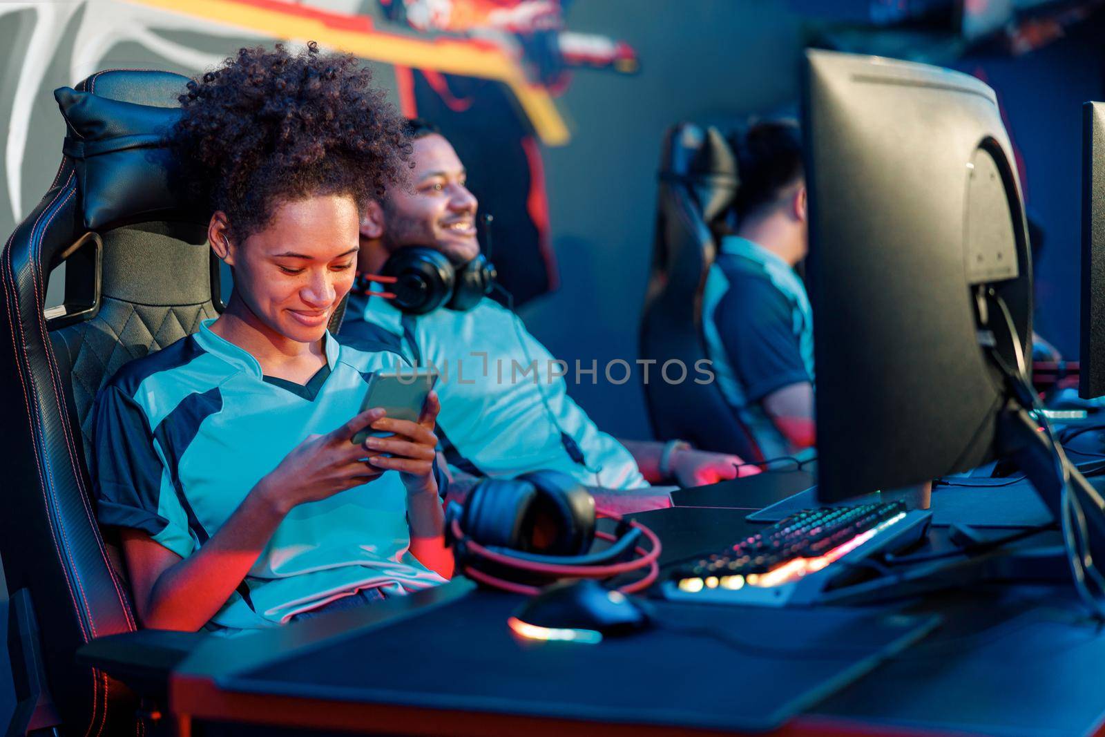 African female cybersport gamer have live stream and playing game on smart phone in gaming club