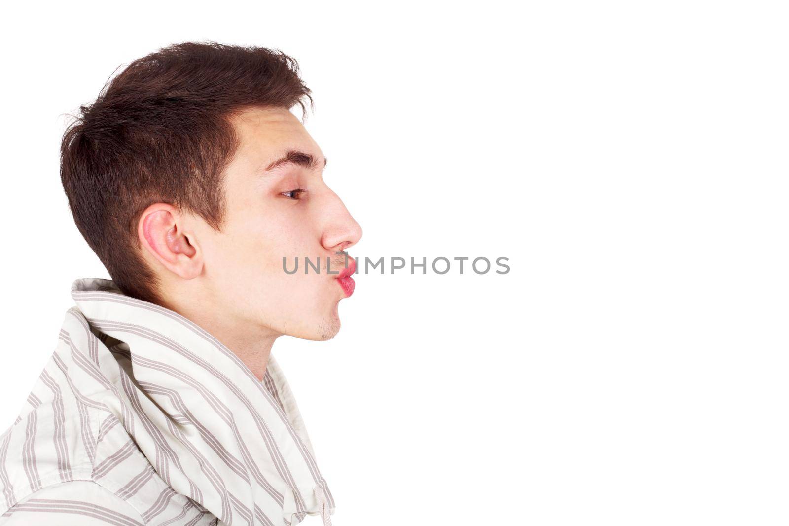profile of the young handsome guy imitating a kiss, copy space