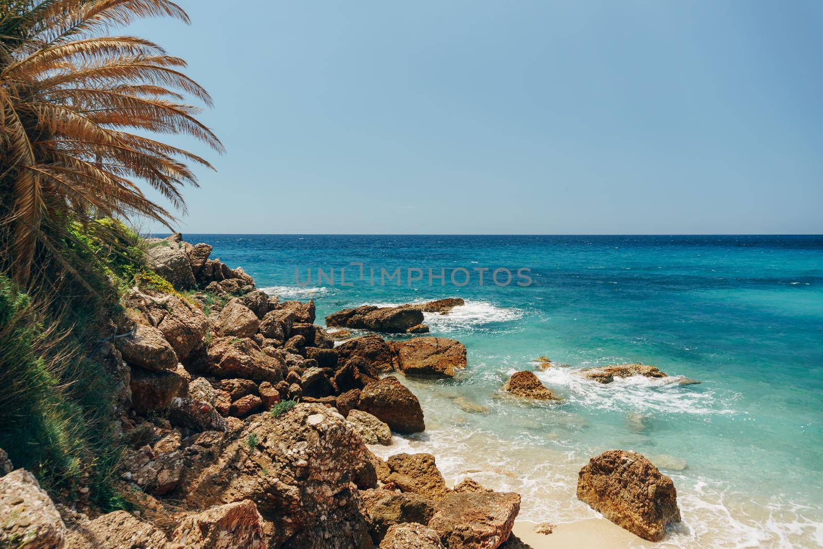 Huge boulders and clear water on the Drobni Pijesak beach. High quality photo