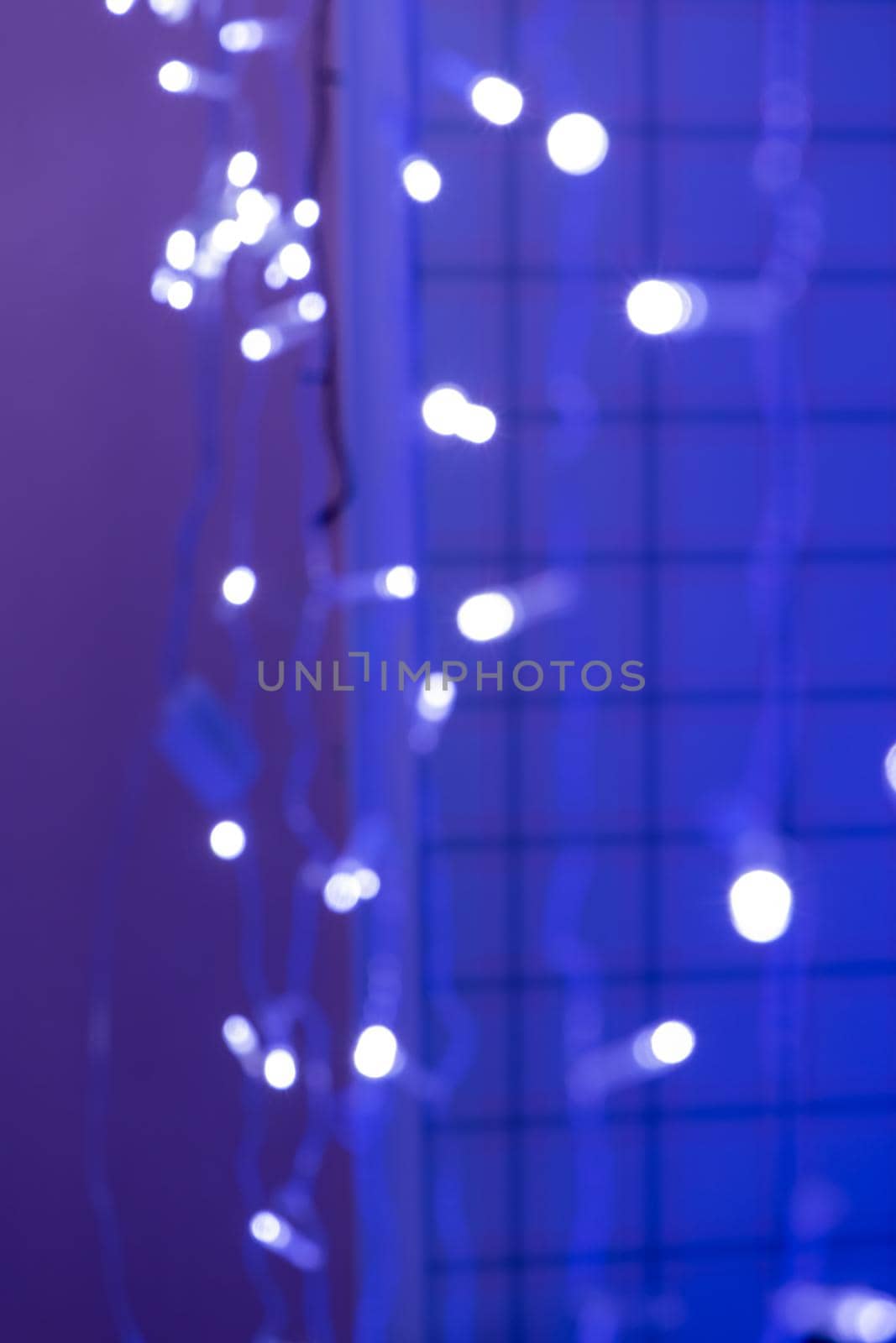 Christmas lights at night. Blurred background. Festive concept. Space for copying. Bokeh, selective soft focus