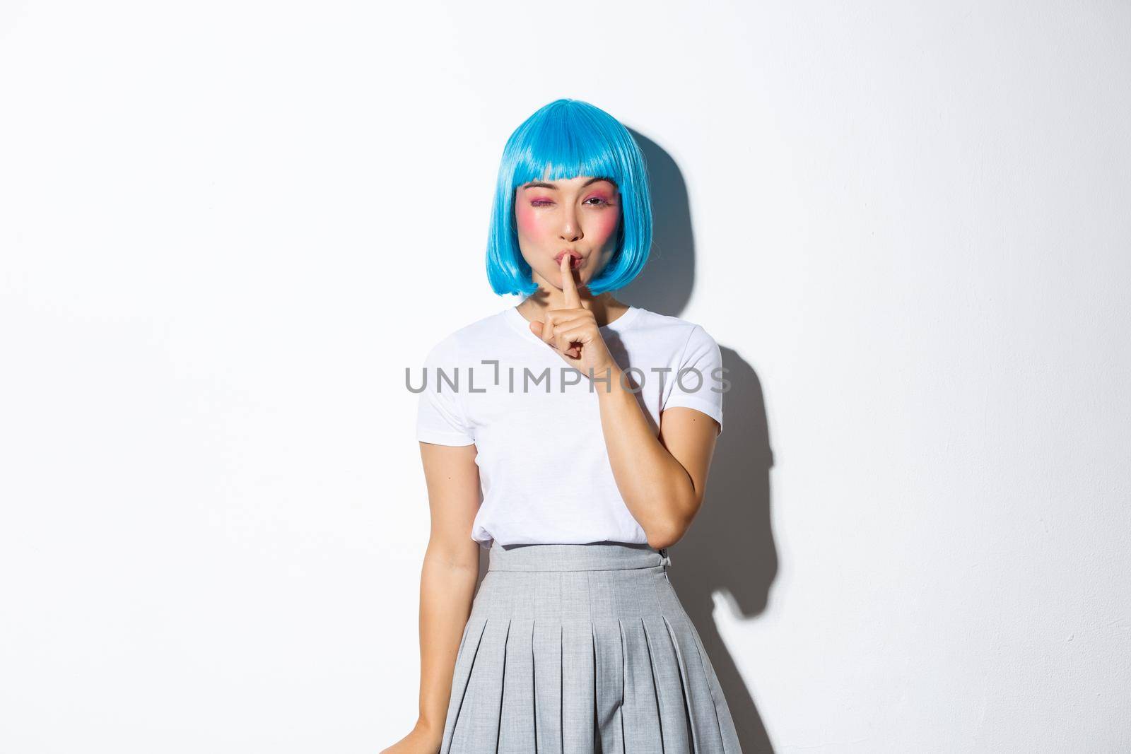 Sassy coquettish asian girl in blue wig have a secret, winking and shushing at camera with sensual expression, wearing blue short wig and halloween costume, white background by Benzoix