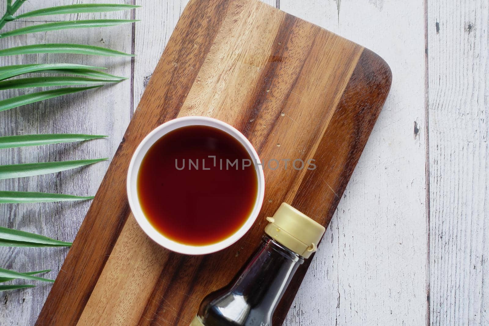 Japanese food cooking set with soy sauce, bamboo sticks on wooden table