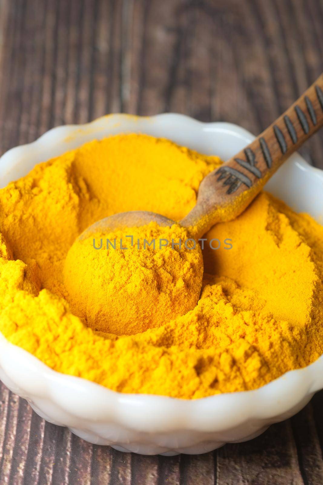turmeric ginger powder in a in bowl on table , by towfiq007