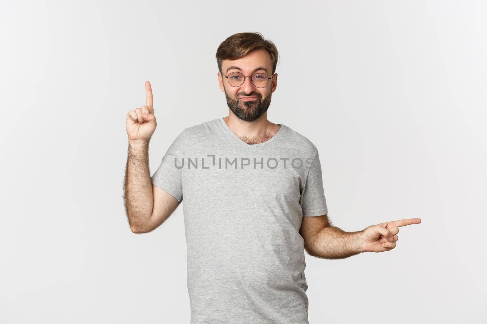 Indecisive bearded guy with beard, pointing up and right, showing two variants, making choice, standing over white background.