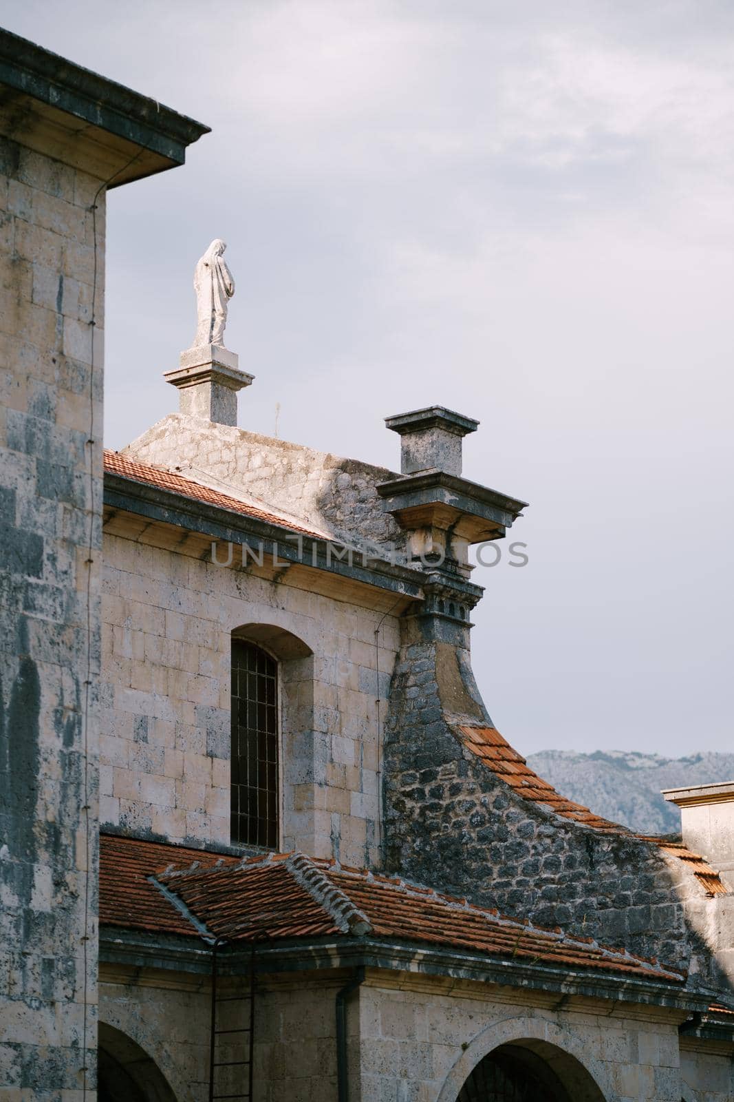 Statue on the roof of the Church of the Nativity of the Virgin in Prcanj. High quality photo