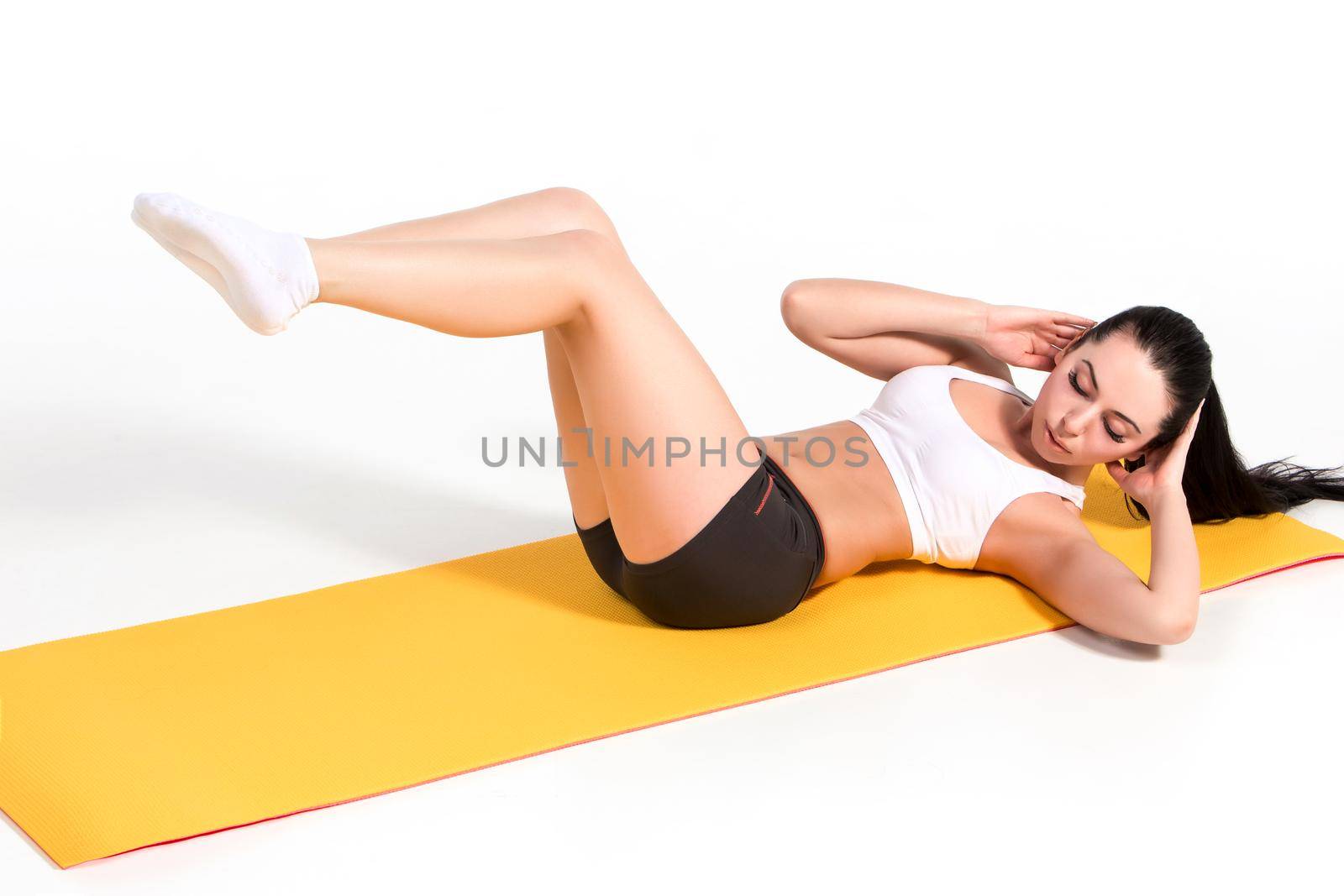 Portrait of young attractive woman doing exercises. Brunette with fit body on yoga mat. Healthy lifestyle and sports concept. Series of exercise poses.