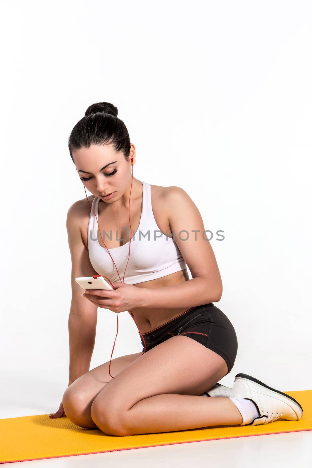 Brunette with fit body on yoga mat by nazarovsergey