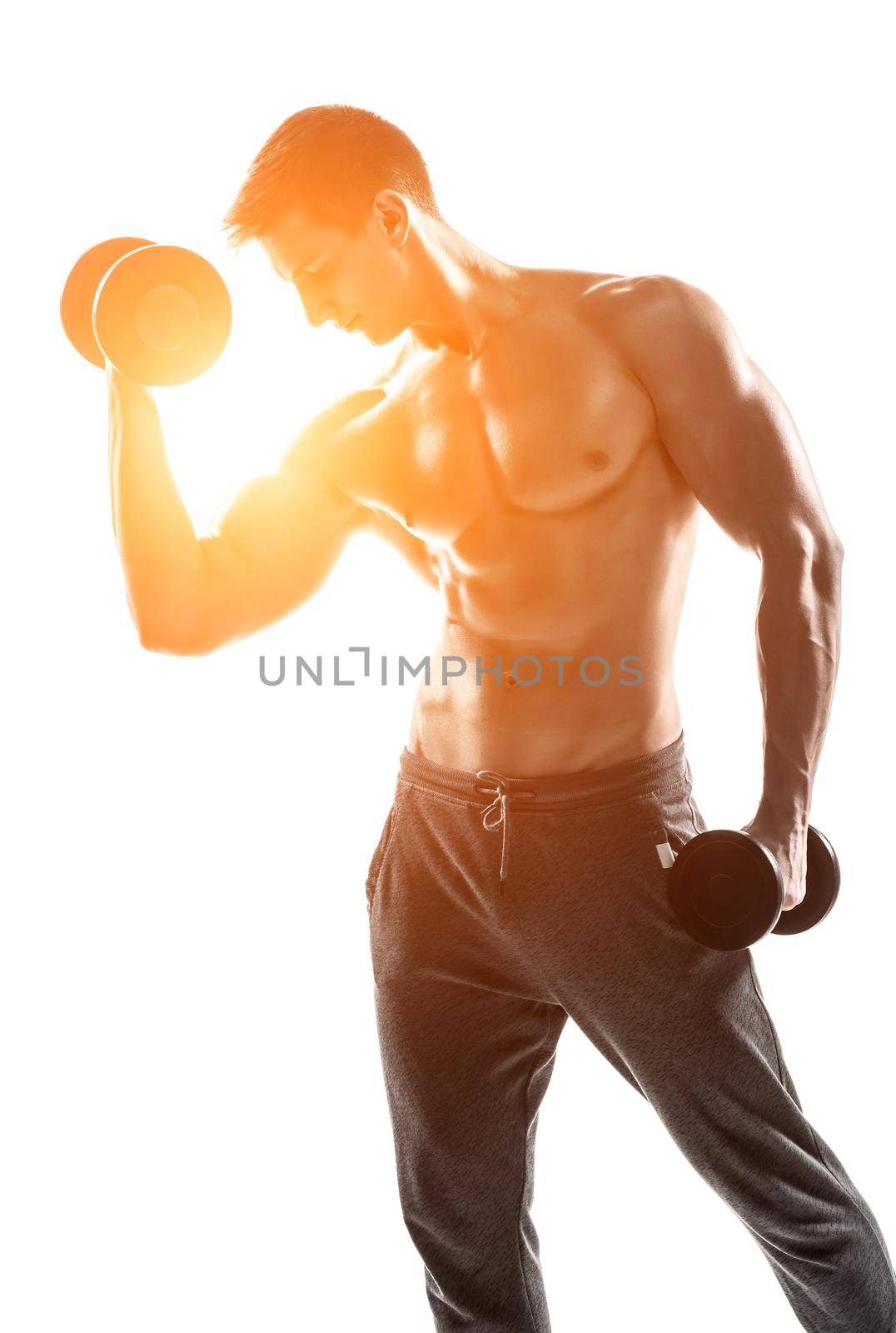 Handsome muscular man doing exercises with dumbbells isolated on white background Whith solar flare