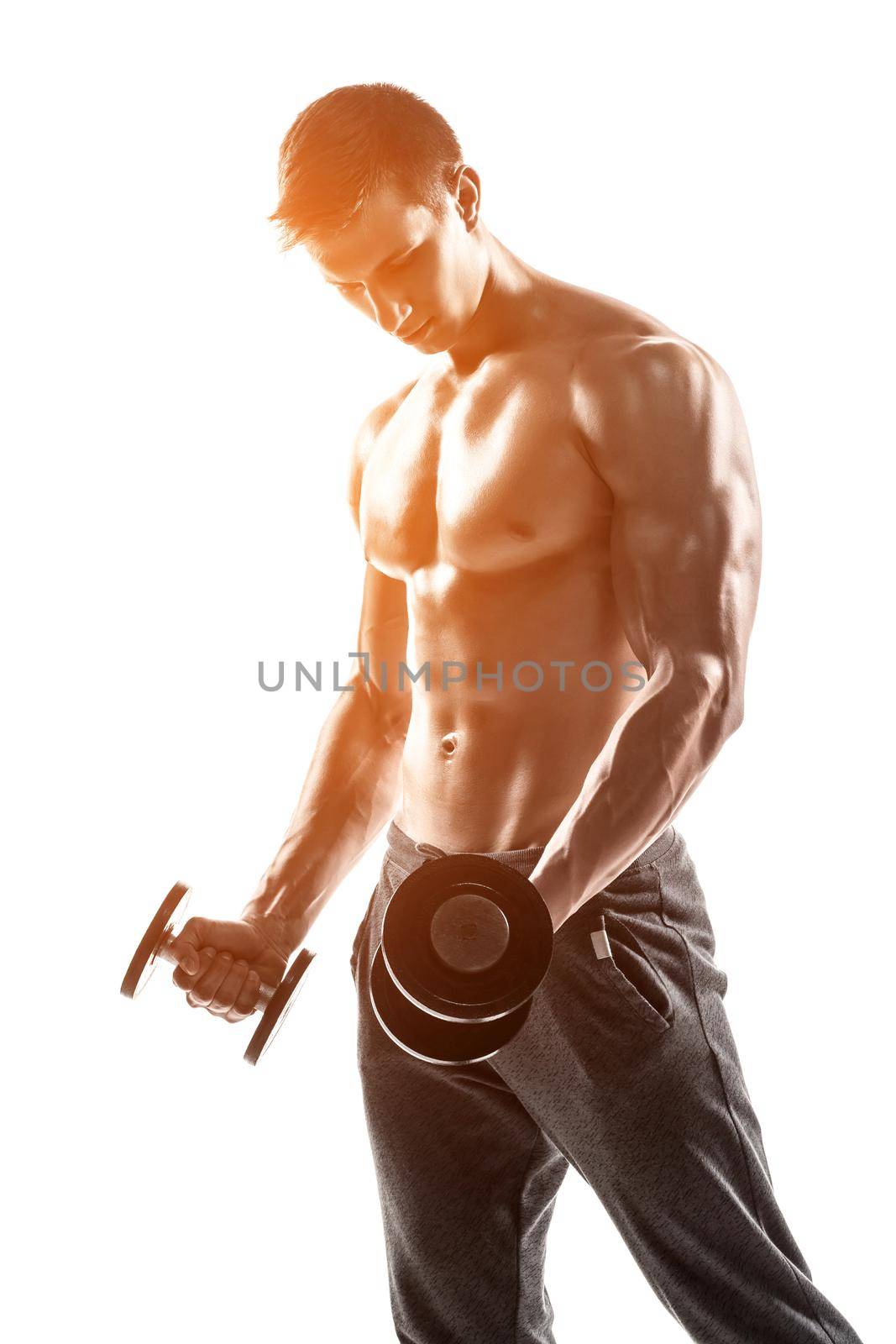 Handsome muscular man doing exercises with dumbbells isolated on white background Whith solar flare