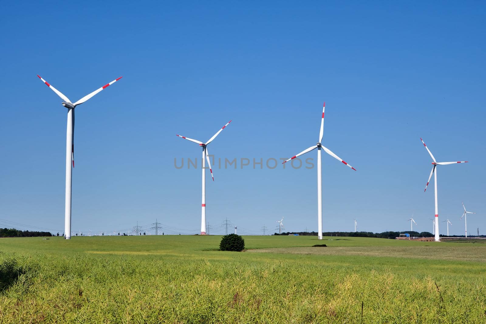 Wind turbines in front of a clear blue sky seen in Germany