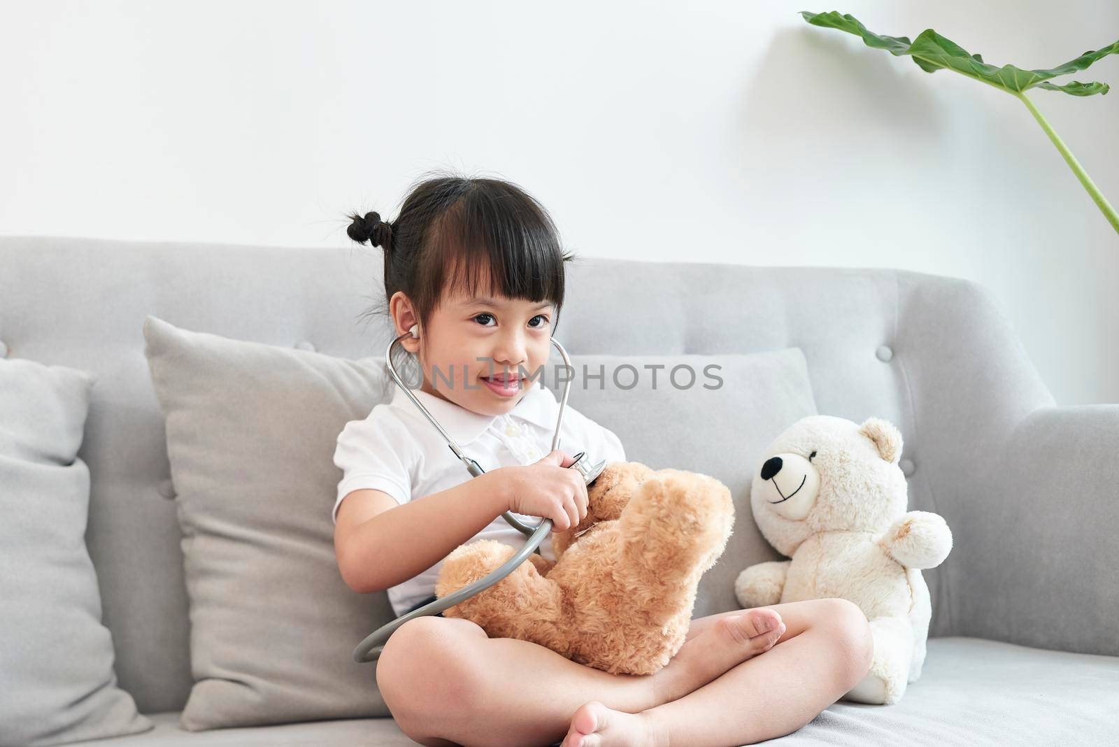 A doctor girl playing and cure bear at the pediatric