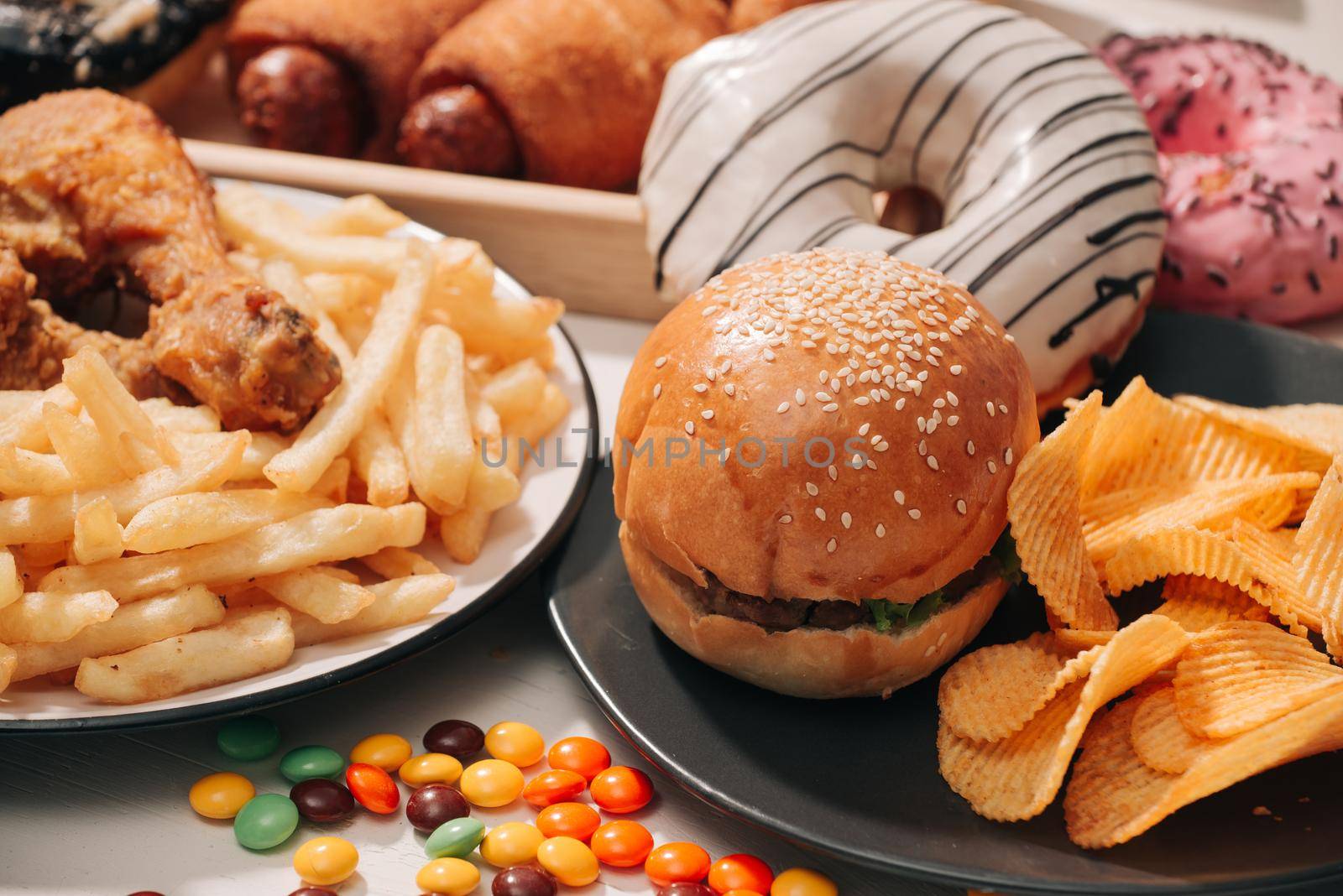 fast food and unhealthy eating concept - close up of fast food snacks and cola drink on white table  by makidotvn