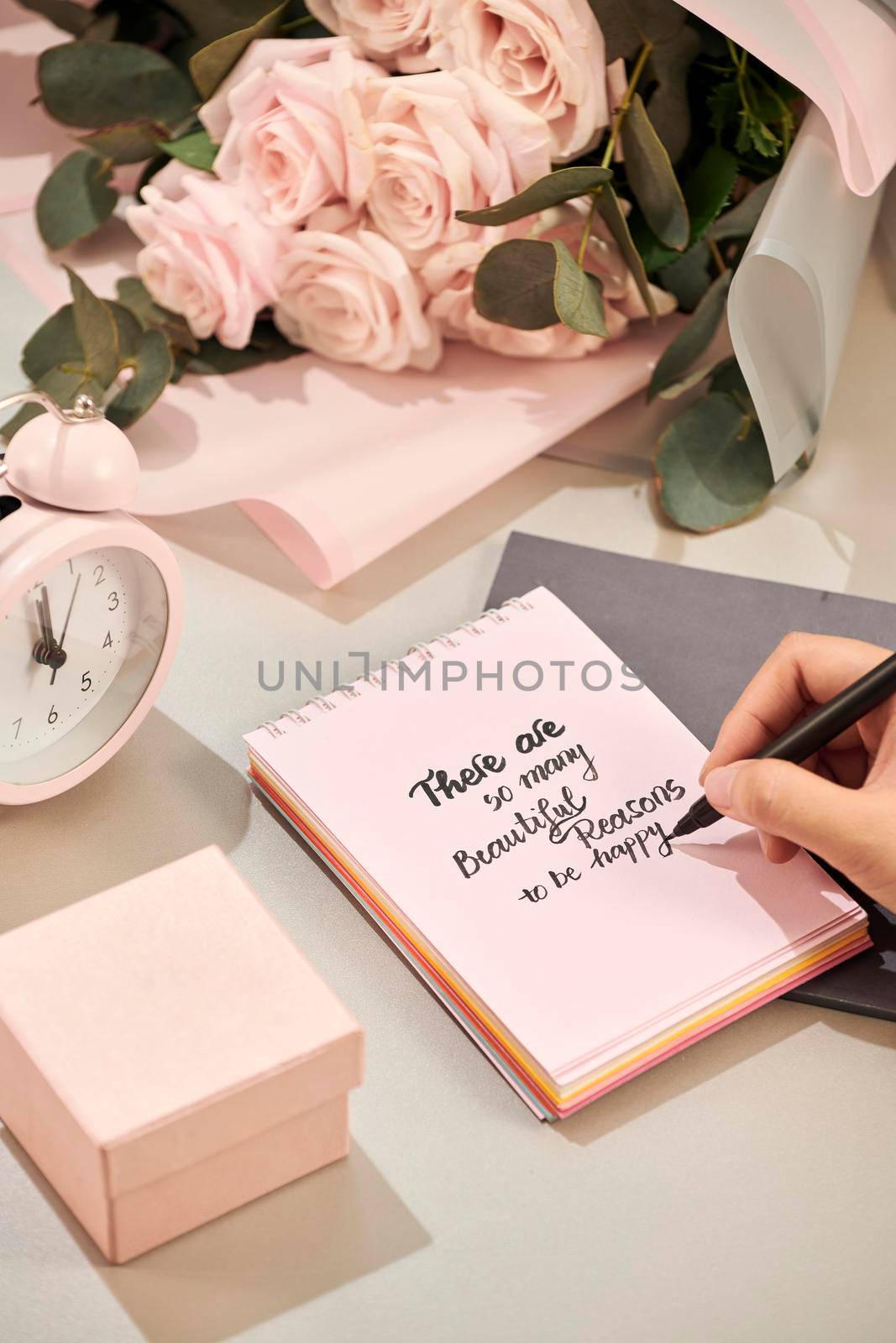 Woman hands holding pen, ready to write. Pink rose,  pen and gift with pink heart on white table. Love concept. Saint Valentine's Day concept. Mother's day concept. by makidotvn