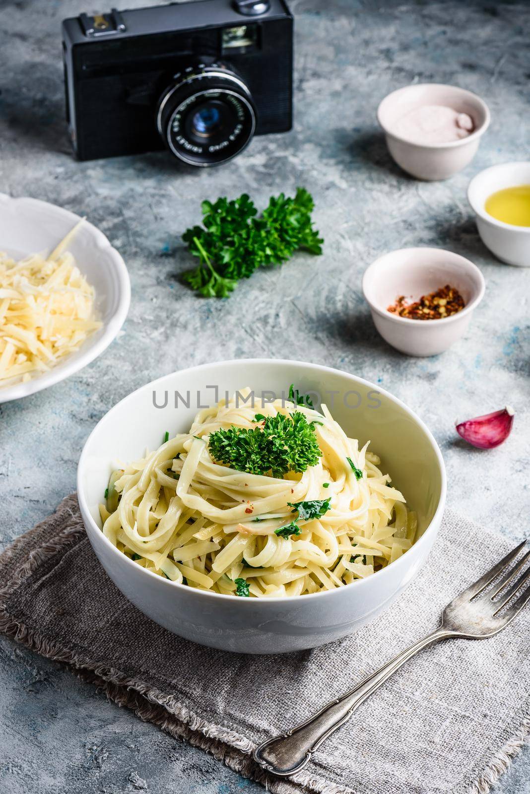 Easy lunch recipe. Linguine pasta with olive oil, garlic, fresh parsley and grated parmesan cheese.