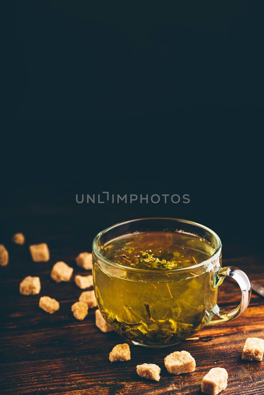 Cup of green tea with brown tea sugar by Seva_blsv