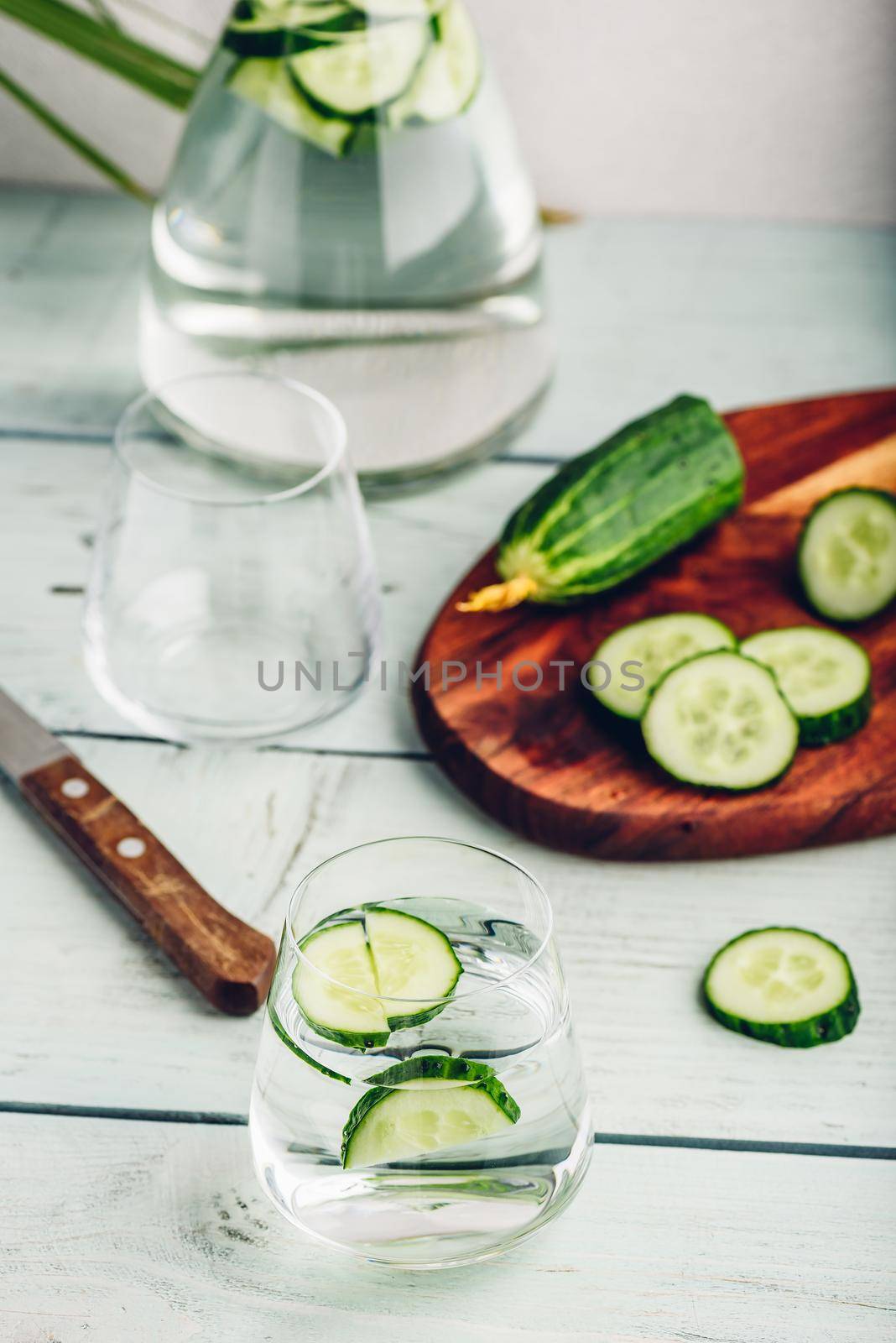 Water infused with sliced cucumber in a drinking glass