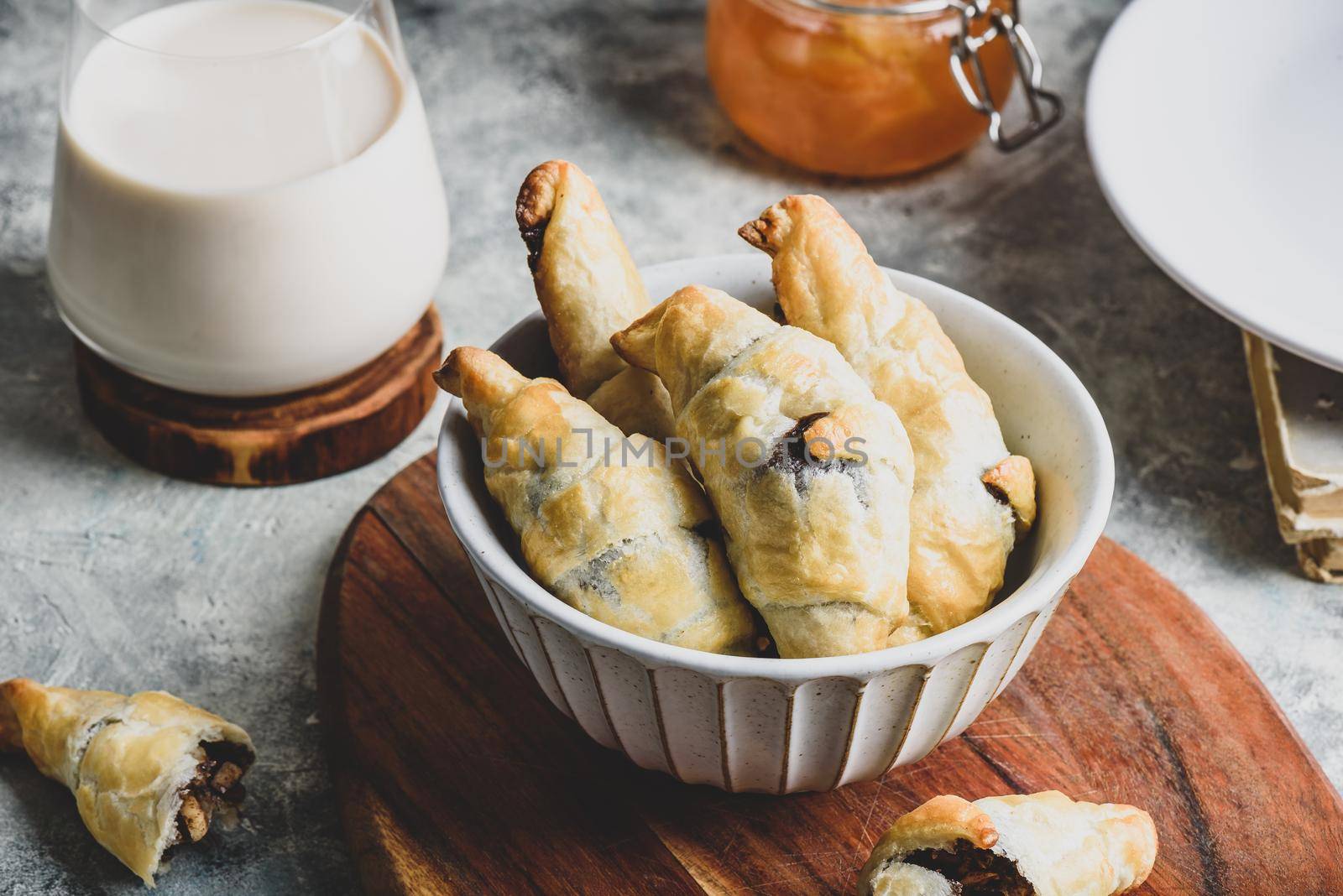 Bowl of fresh baked croissants stuffed with nuts and chocolate spread