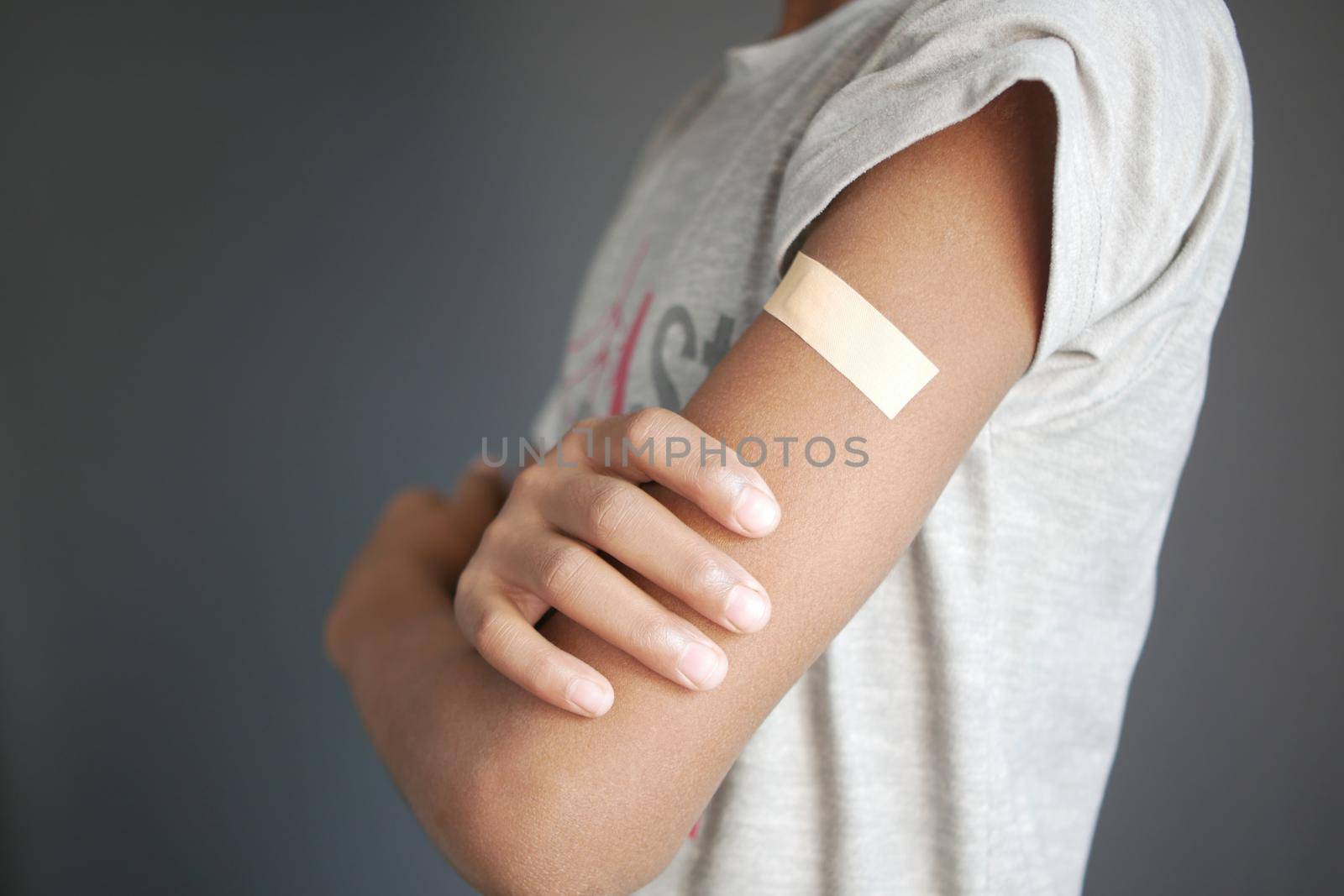 adhesive bandage on young man's arm .