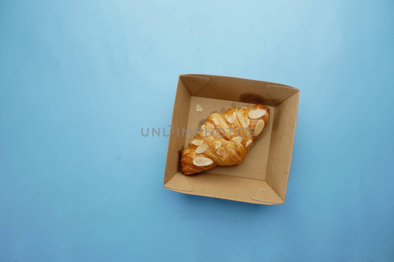 fresh baked croissant in a bow on table .