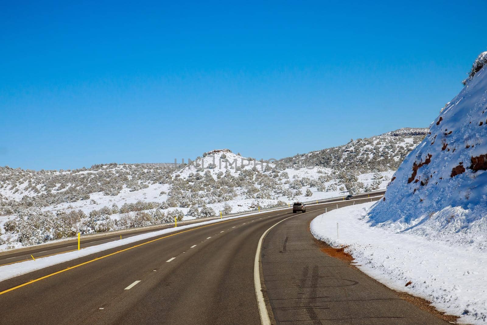 Panorama view of snowy mountain desert after the snowstorm in Arizona winter with of Interstate I-17 by ungvar