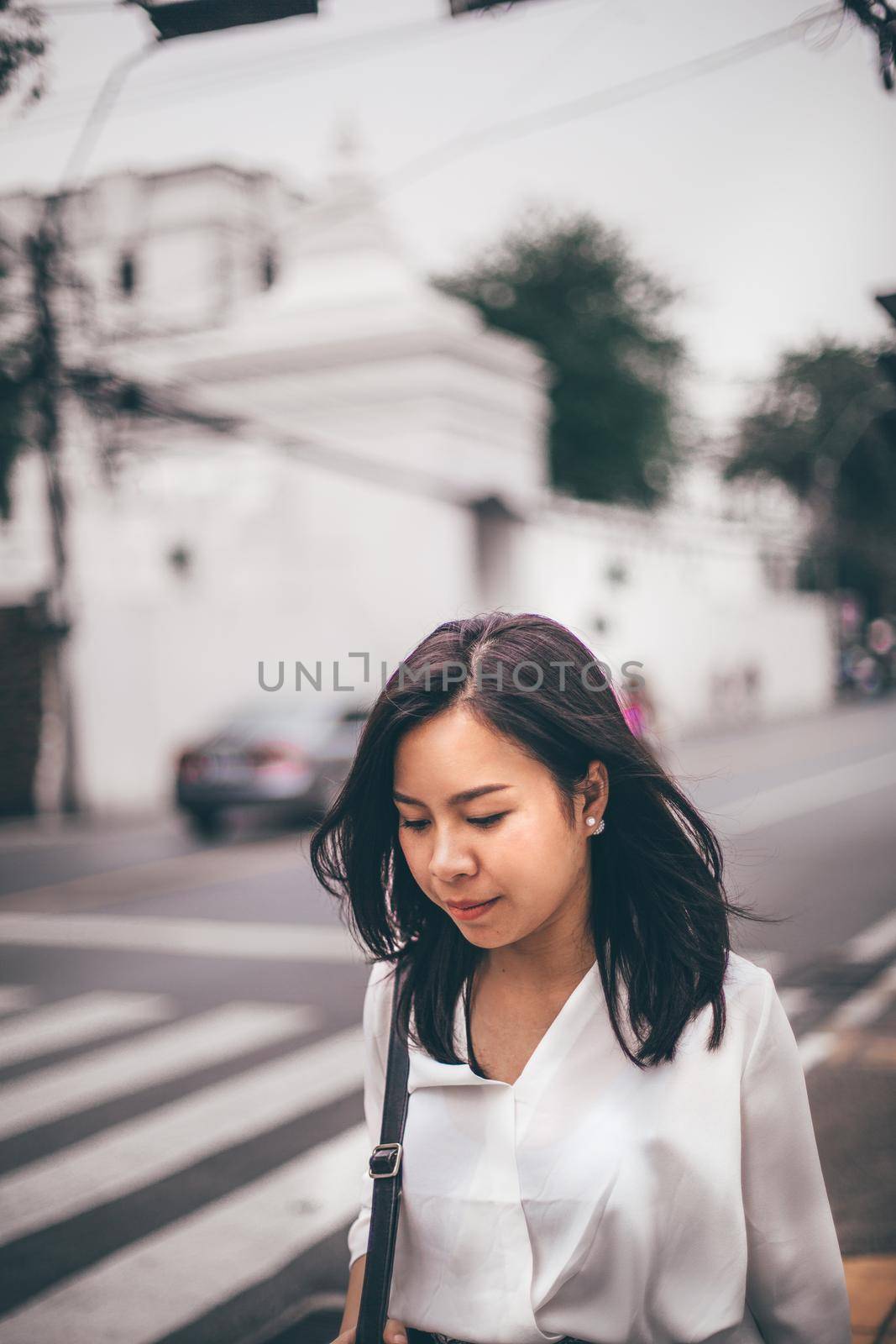 Young Asian beautiful businesswoman walking on street hurry to work