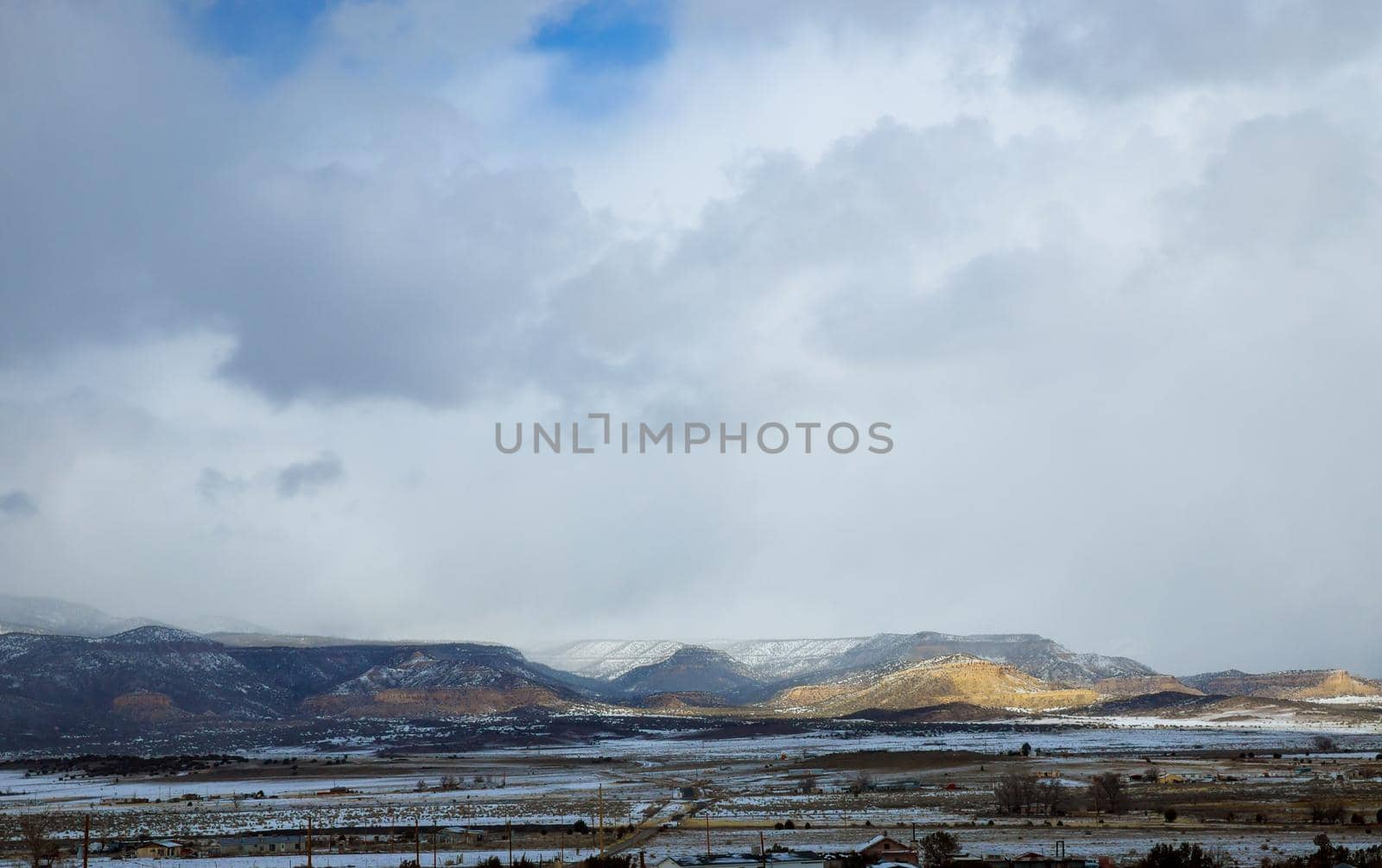Hazardous winter weather along a high rocky mountains on I-40 highway with winter snow covered landscape in the New Mexico USA