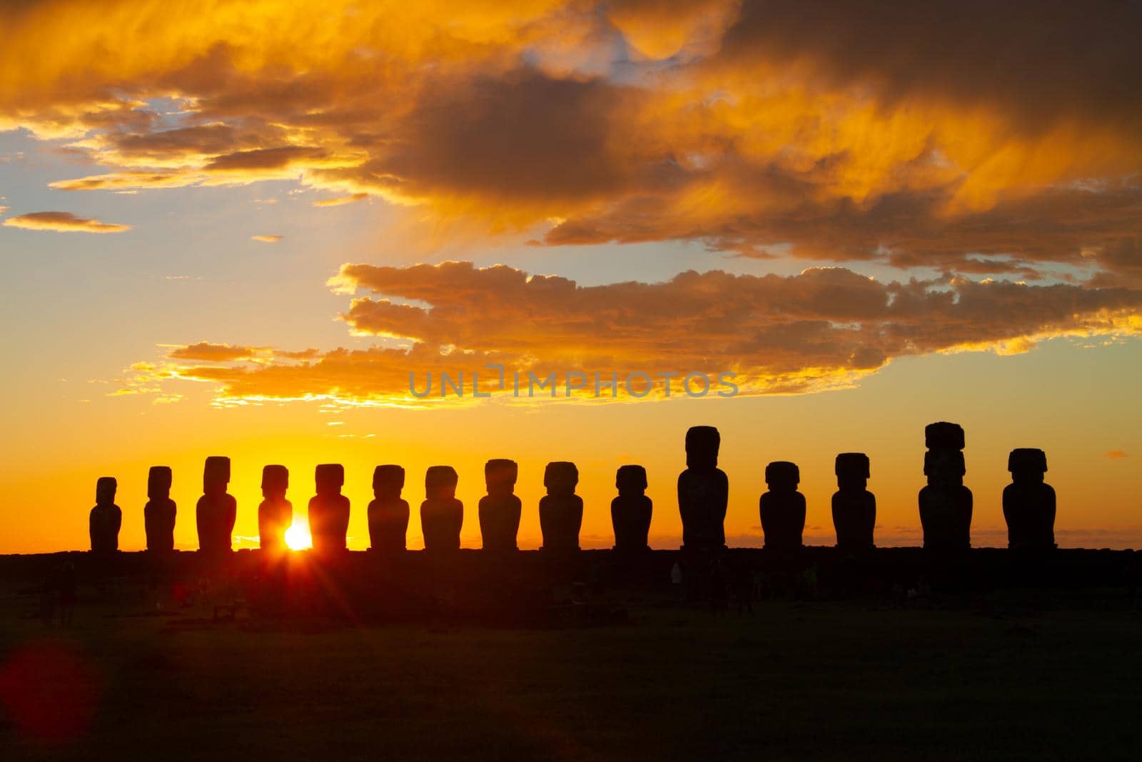 Dramatic colorful sunrise over Moai stone sculptures at Ahu Tongariki, Easter island, Chile. by kasto